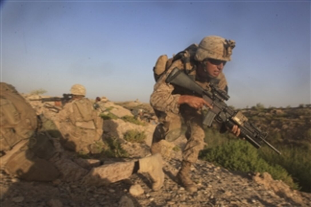 U.S. Marine Corps Lance Cpl. Lionel Ortiz with Bravo Company, 1st Battalion, 5th Marine Regiment changes cover position during a firefight in the Nawa district of Helmand province, Afghanistan, on Aug. 14, 2009.  The battalion is deployed with Regimental Combat Team 3 to conduct counter insurgency operations in partnership with Afghan National Security Forces in southern Afghanistan.  
