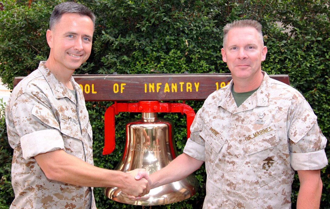 Colonel Timothy S. Mundy(left), commanding officer, School of Infantry East, shakes hands with Col. Brennan T. Byrne, commanding officer, SOI West, as the two met in an effort to collaborate their approach to training on Camp Pendleton, Aug. 18.::r::::n::::r::::n::Mundy was recently appointed as the commander of SOI East May 29 and met with Byrne to discuss any differences in curriculum and new training developments.::r::::n::::r::::n::The Marine Corps is unique in that it has entry level training on both coasts, said Byrne. Communication between the two commanders is vital to coordinate quality training.::r::::n::::r::::n::"There are differences based on the location," said Mundy. "But regardless of which side he came from he is the same Marine."::r::::n::::r::::n::Mundy also had the opportunity to witness the graduation of 243 Marines from SOI West's Marine Corps Combat Training later that day.::r::::n::::r::::n::"I may be new to the school of infantry, but we still produce Marines of the highest caliber," added Mundy.::r::::n::