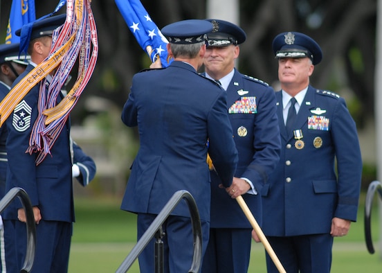 HICKAM AIR FORCE BASE, Hawaii – Gen. Gary North, Pacific Air Forces commander, accepts the PACAF flag from Gen. Norton A. Schwartz, Air Force Chief of Staff, during a change of command ceremony here Aug. 19. Navy Adm. Timothy Keating, Commander of United States Pacific Command, also presided over the change of command ceremony by passing the PACOM Air Component flag to General North, as he also assumes command as the air component commander of PACOM. The outgoing commander, Gen. Howie Chandler, is on his way to Washington D.C., to report to his new assignment as the Air Force Vice Chief of Staff. Chief Master Sgt. Anthony Bishop, PACAF command chief, assisted with the passing of the flags. (U.S. Air Force photo/Staff Sgt. Mike Meares)