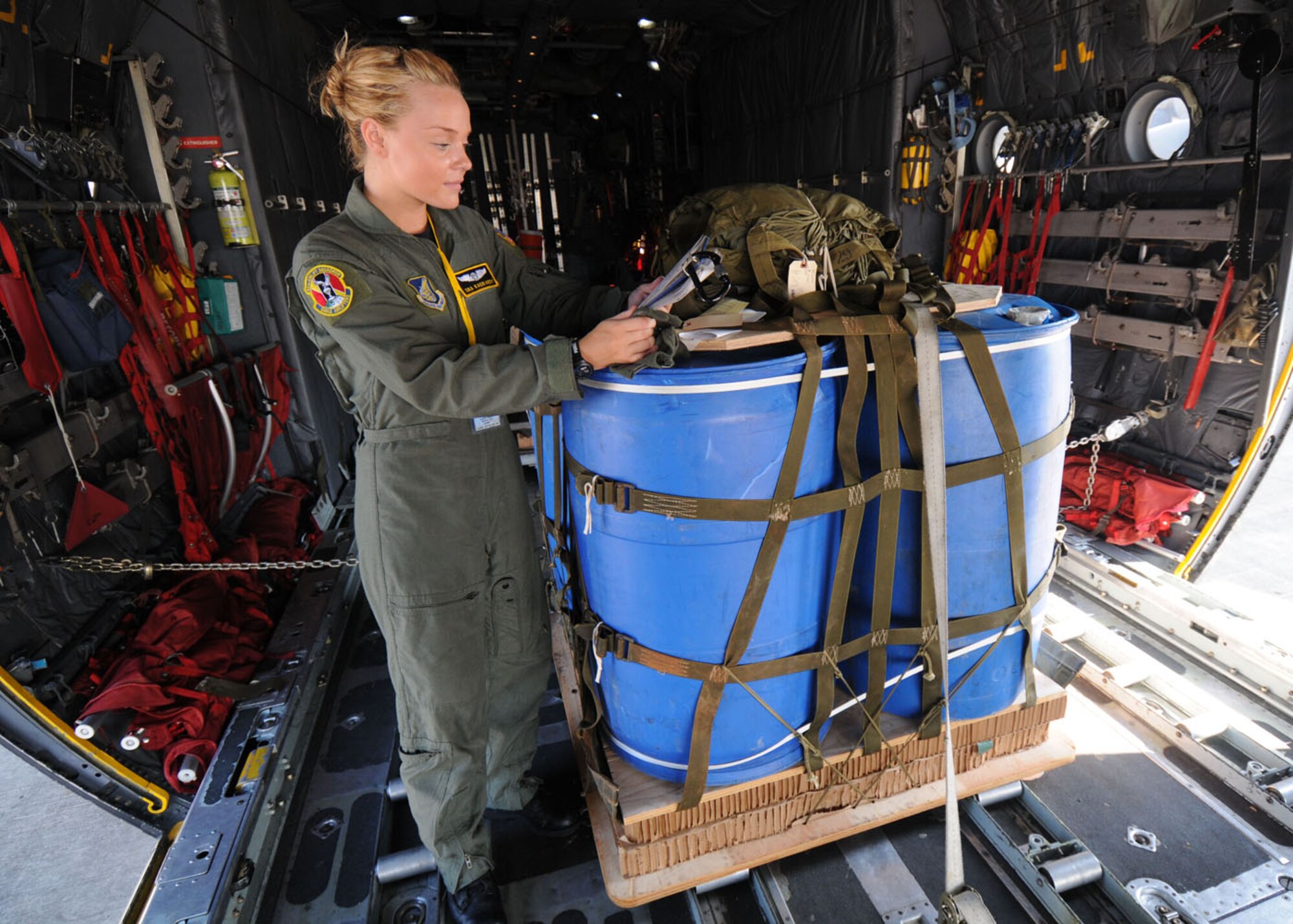 SUBANG ROYAL MALAYSIAN AIR FORCE BASE, Malaysia -- Senior Airman Kacie Adsit, 36th Airlift Squadron loadmaster from Yokota Air Base, Japan, reads through technical orders before a heavy equipment drop from a C-130 Hercules Aug. 19 during the 2009 Pacific Airlift Rally here. The PAR is a bi-annual exercise involving Pacific Rim nations which enhances military airlift interoperability with a focus in humanitarian assistance and disaster relief operations. The exercise consista of a tabletop exercise and a field training exercise involving three C-130 aircraft from the 374th Airlift Wing at Yokota and one C-130 each from the Royal Malaysian Air Force, Royal Australian Air Force, Republic of Singapore Air Force and Royal New Zealand Air Force. (U.S. Air Force photo/Staff Sgt. Veronica Pierce)