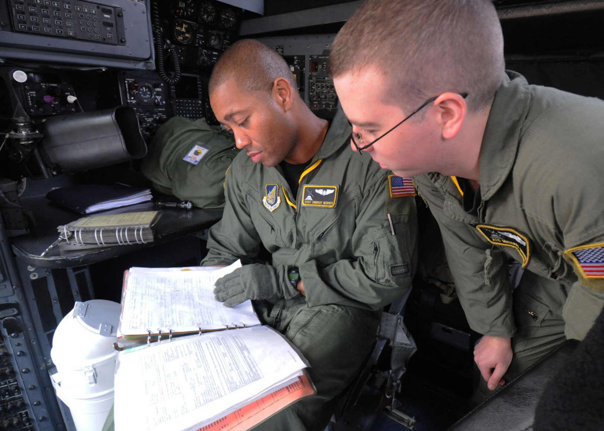 SUBANG ROYAL MALAYSIAN AIR FORCE BASE, Malaysia -- Staff Sgt. Undray Morris, 36th Airlift Squadron flight engineer (left) and Airman 1st Class Michael Mason, 36th AS loadmaster, check the status of C-130 Hercules forms before take-off Aug. 19 during the 2009 Pacific Airlift Rally here. The PAR is a bi-annual exercise involving Pacific Rim nations which enhances military airlift interoperability with a focus in humanitarian assistance and disaster relief operations. The exercise consists of a tabletop exercise and a field-training exercise involving three C-130 aircraft from the 374th Airlift Wing at Yokota Air Base, Japan, and one C-130 each from the Royal Malaysian Air Force, Royal Australian Air Force, Republic of Singapore Air Force and Royal New Zealand Air Force. (U.S. Air Force photo/ Staff Sgt. Veronica Pierce)