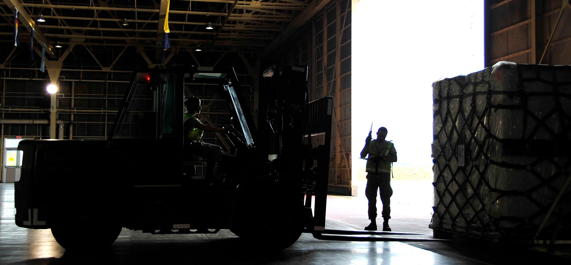 MISAWA AIR BASE, Japan -- Airmen of the 35th Logistics Readiness Squadron load deployment cargo in hangar 949 during a base exercise August 18. 35th LRS loaded approximately one hundred thousand pounds of deployment cargo. (U.S. Air Force photo/Staff Sgt. Chad C. Strohmeyer)