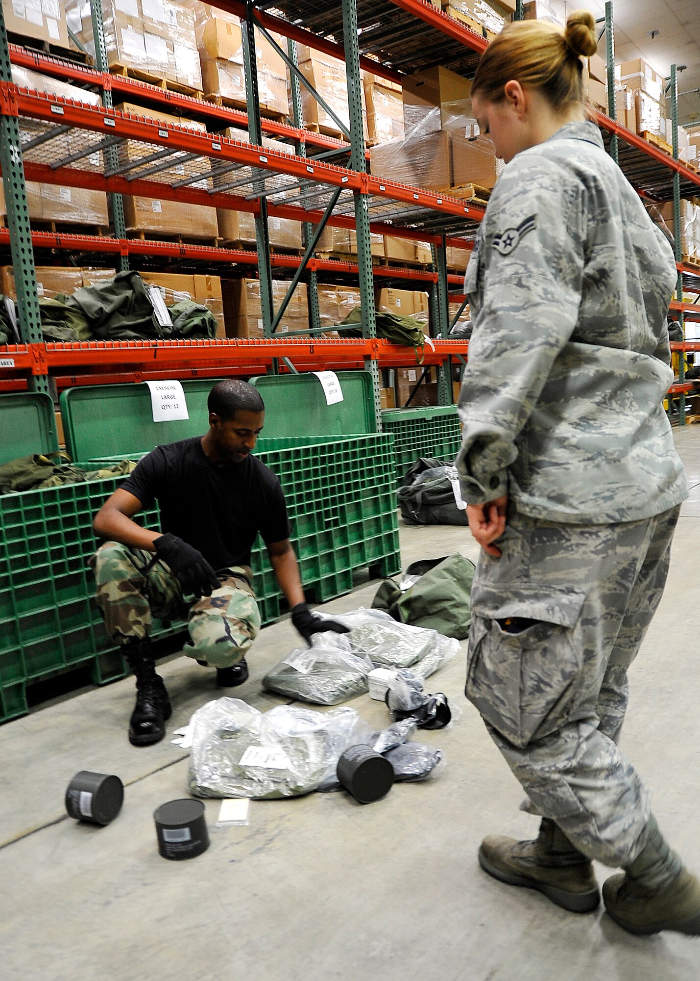 MISAWA AIR BASE, Japan -- Staff Sgt. Jeffrey Rose, 35th Logistics Readiness Squadron individual protection equipment element NCO in charge, inspects a C-1 bag during a base exercise August 18. The IPE element processed approximately 100 C-1 bags during the three-day exercise. (U.S. Air Force photo/Staff Sgt. Chad C. Strohmeyer)