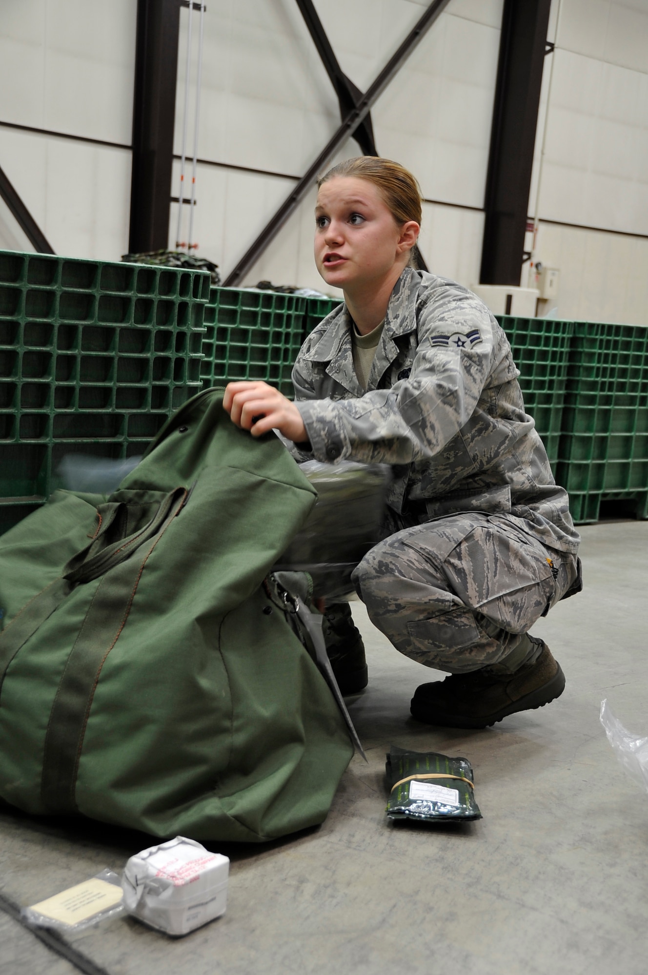 MISAWA AIR BASE, Japan -- Airman 1st Class Alexandria Shelly, 35th Logistics Readiness Squadron individual protective equipment element administrator, inspects a C-1 chemical protection bag Aug. 18 at Building 1334. The C-1 bag is one of three bags inspected during a pre-deployment exercise. (U.S. Air Force photo/Staff Sgt. Chad C. Strohmeyer) 