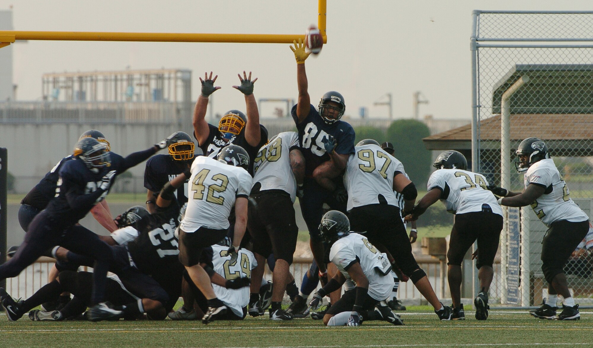 YOKOSUKA, Japan -- The Yokota Warriors' defense forces Yokosuka into a missed point after attempt during Yokota's 18-12 defeat of the Seahawks Aug. 1 in a semi-final game of the U.S. Forces Japan-American Football League playoffs. Yokota earned its third Torii Bowl, or championship, berth since the USFJ-AFL began in 2000. The Warriors lost at Yokosuka 15-12 in 2000 and 30-21 at Misawa in 2005. Yokota travels to Kadena Air Base Aug. 28 to take on Camp Foster in the championship game. (U.S. Air Force photo/Master Sgt. Matt Summers) 
