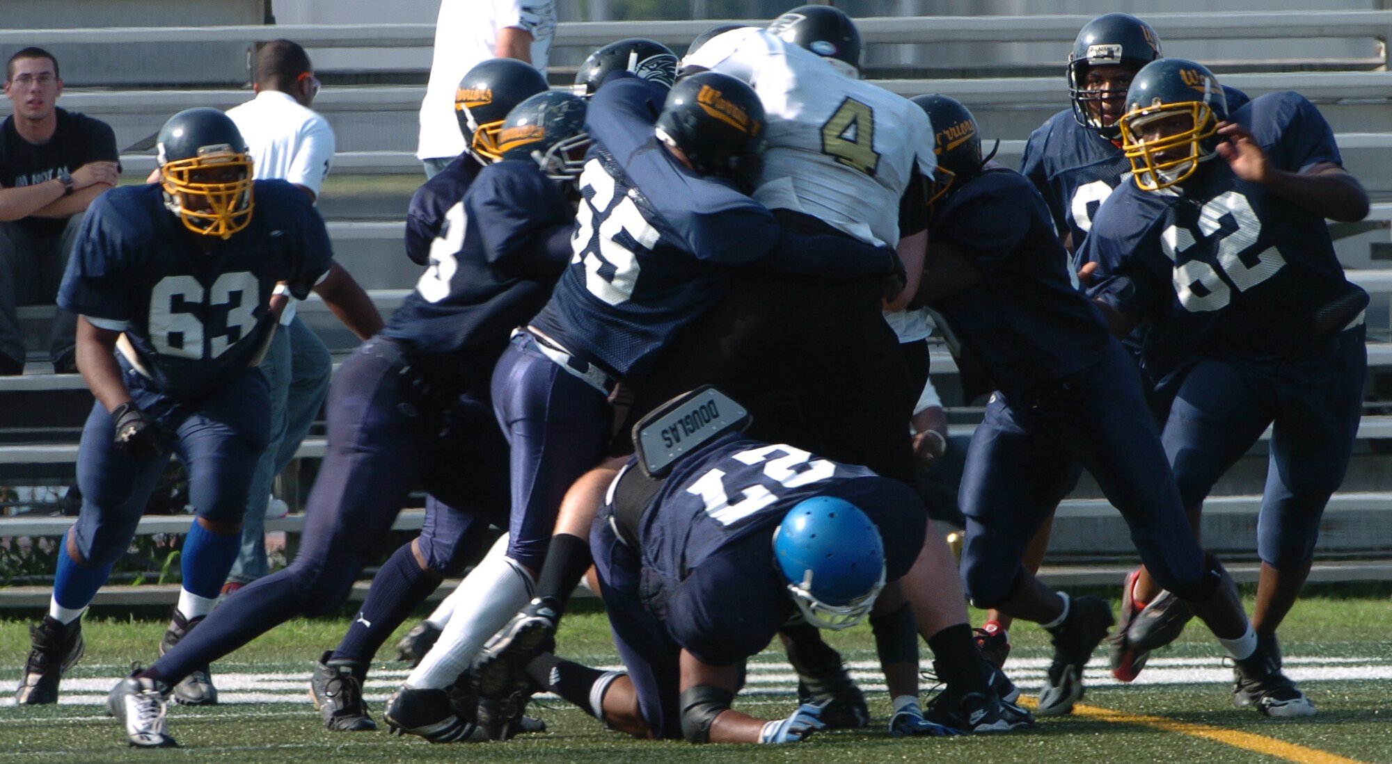 YOKOSUKA, Japan -- The entire Yokota Warriors' defense makes a goal-line stand against Bob Docherty, the 6-foot-6-inch, 280-pound quarterback of the Yokosuka Seahawks during Yokota's 18-12 defeat of the Yokosuka Aug. 1 in a semi-final game of the U.S. Forces Japan-American Football League playoffs. Yokota earned its third Torii Bowl, or championship, berth since the USFJ-AFL began in 2000. The Warriors lost at Yokosuka 15-12 in 2000 and 30-21 at Misawa in 2005. Yokota travels to Kadena Air Base Aug. 28 to take on Camp Foster in the championship game. (U.S. Air Force photo/Master Sgt. Matt Summers) 