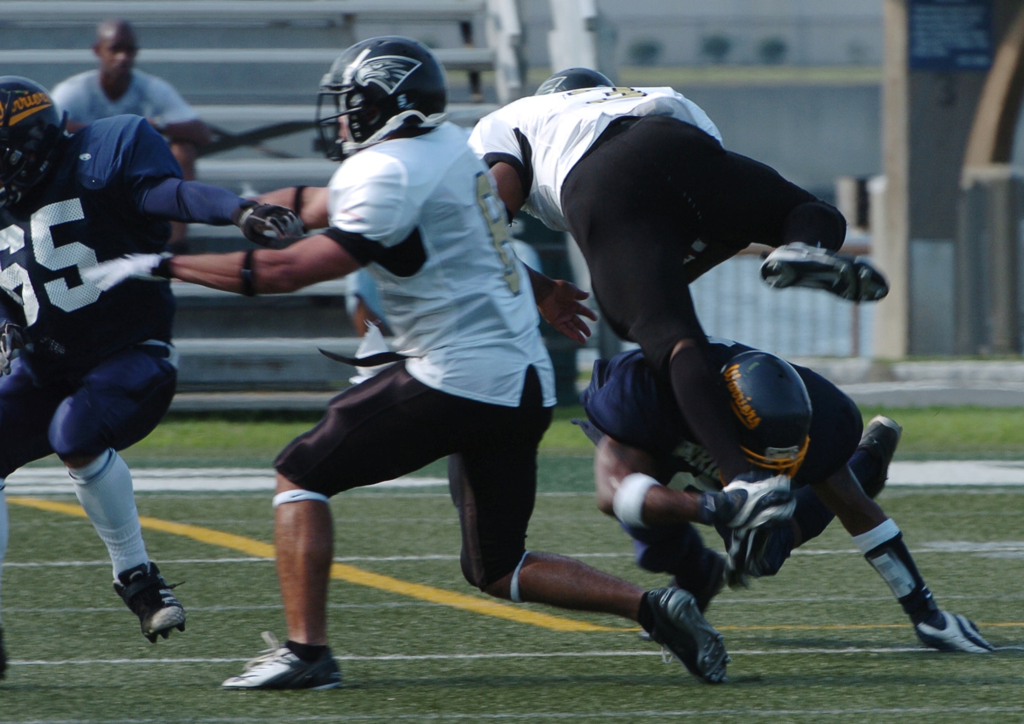 YOKOSUKA, Japan -- Yokota Warriors' free safety Frederick Guild upends a Yokosuka runner during Yokota's 18-12 defeat of the Seahawks Aug. 1 in a semi-final game of the U.S. Forces Japan-American Football League playoffs. Yokota earned its third Torii Bowl, or championship, berth since the USFJ-AFL began in 2000. The Warriors lost at Yokosuka 15-12 in 2000 and 30-21 at Misawa in 2005. Yokota travels to Kadena Air Base Aug. 28 to take on Camp Foster in the championship game. (U.S. Air Force photo/Master Sgt. Matt Summers) 