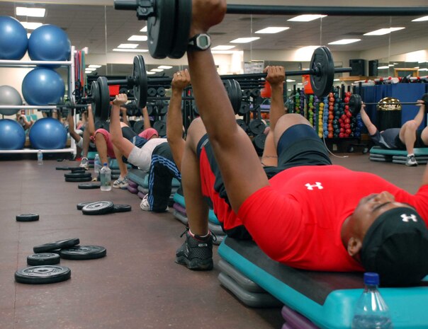Master Sgt. Keith Vernon, 9th Force Support Squadron, bench presses his barbell Aug. 17 at the fitness center. Sergeant Vernon, along with other active-duty Airmen are training to be the only certified Body Pump instructors in the Air Force. (Photo by Sandy Healy)