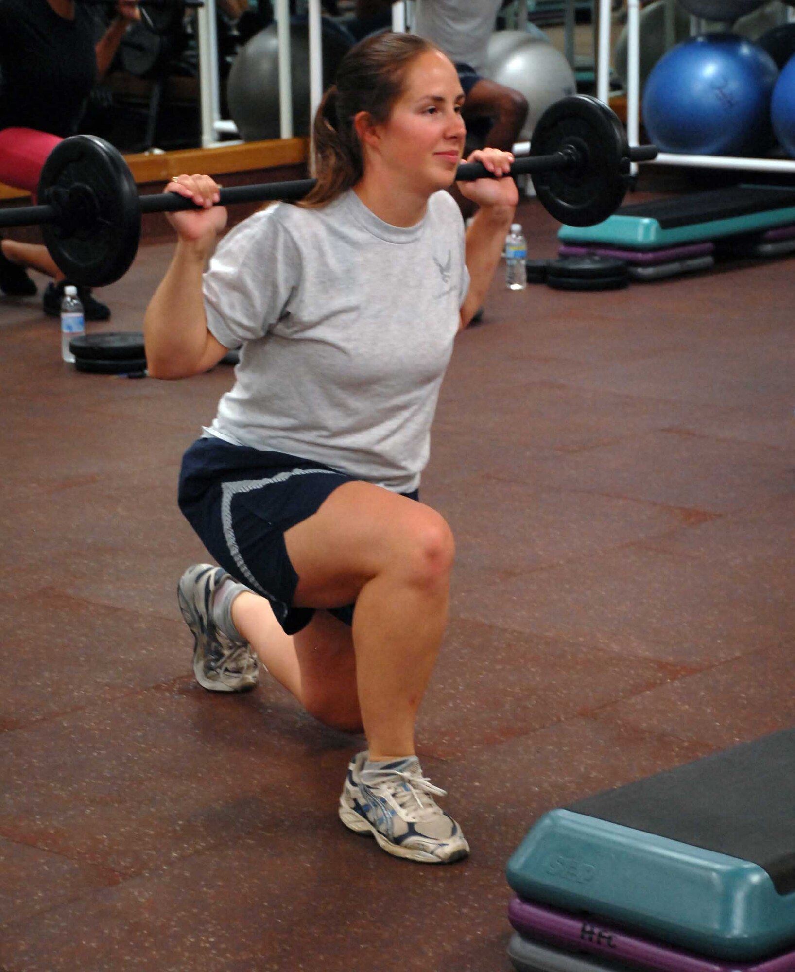 1st Lt. Melissa Croy does lunges using a Body Pump barbell Aug. 17, 2009 at the Harris Fitness Center. Instructing Body Pump classes is one of Lieutenant Croy's many extra curricular activities which garnered her the 2010 FSS CGO of the year award for ACC. (Photo by Airman 1st Class Sandy Healy)