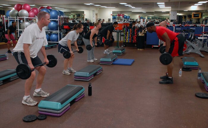 Beale Airmen do a chest exercise Aug. 17 at the Harris Fitness Center. These Airman are perfecting their forms and choreography for the new Body Pump fitness program they will be instructing at Beale. (Photo by Airman 1st Class Sandy Healy)