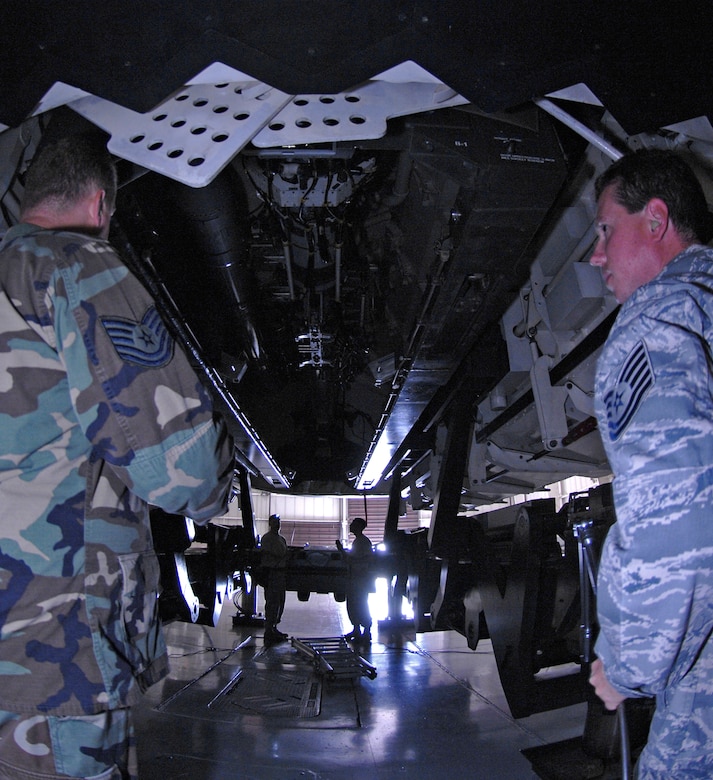 WHITEMAN AIR FORCE BASE, Mo. – Tech. Sgt. Robert Kirkham (left), Loading Standardization Crew member, adjust the weapons trailer into position Aug. 14 as Tech. Sgt. Cary Cook (right), Loading Standardization Crew Team Chief, stands ready to unlock the rotary launch assembly from the Weapons Load Trainer. (U.S. Air Force photo/Staff Sgt. Jason Barebo)