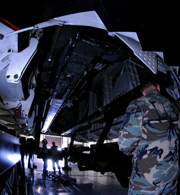 WHITEMAN AIR FORCE BASE, Mo. – Tech. Sgt. Robert Kirkham (right), Loading Standardization Crew member, stands ready Aug. 14 as Tech. Sgts. Ryan Graney (left) and Jason Lease ensure the weapons trailer is lined up correctly with the Weapons Load Trainer’s simulated B-2 weapons bay. Each member of a Weapons Load Crew has a set of specific tasks during loading operations. (U.S. Air Force photo/Staff Sgt. Jason Barebo)