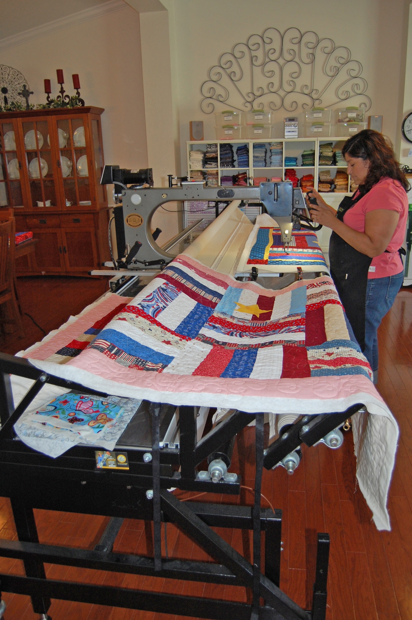 Irene Hafer works on a Quilts of Valor quilt on her longarm machine June 24 in her home studio in Dover, Del. (U.S. Air Force photo/Tech. Sgt. Benjamin Matwey)