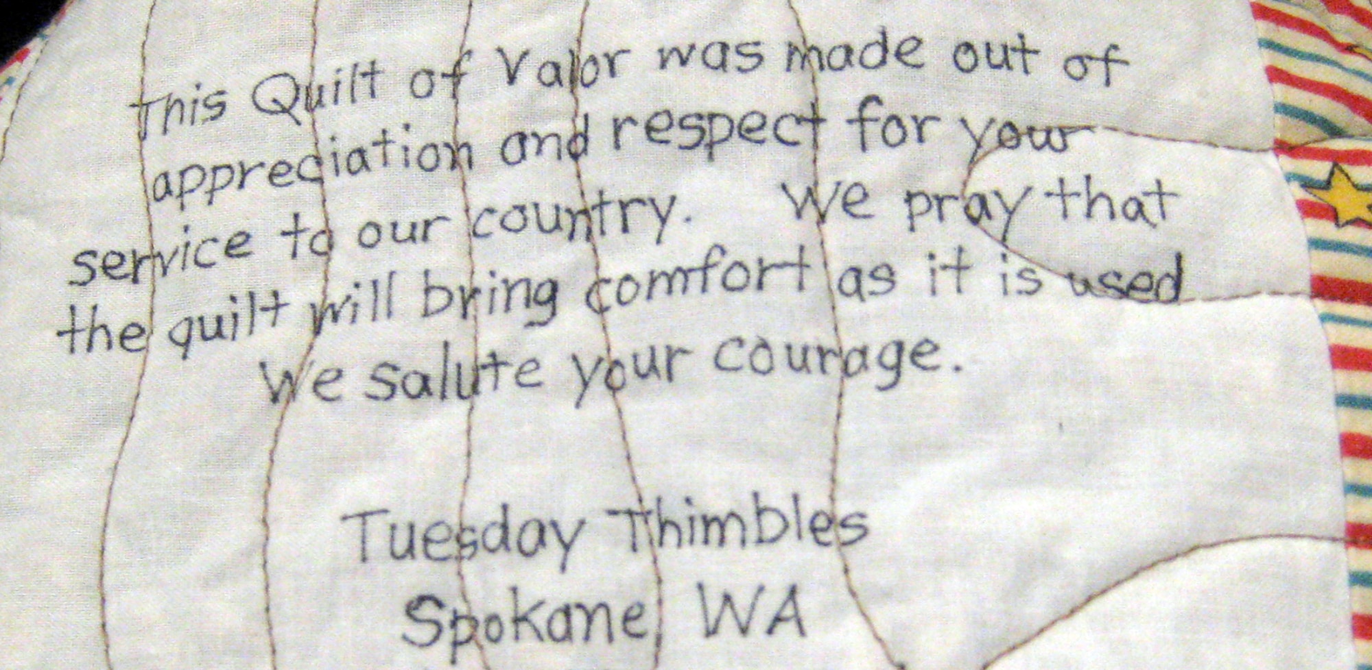 Hundreds of individual quilters and quilting clubs from every region of the nation make Quilts of Valor. This label is on a quilt donated by the Tuesday Thimbles quilting club of Spokane, Wash. (U.S. Air Force photo/Tech. Sgt. Benjamin Matwey)