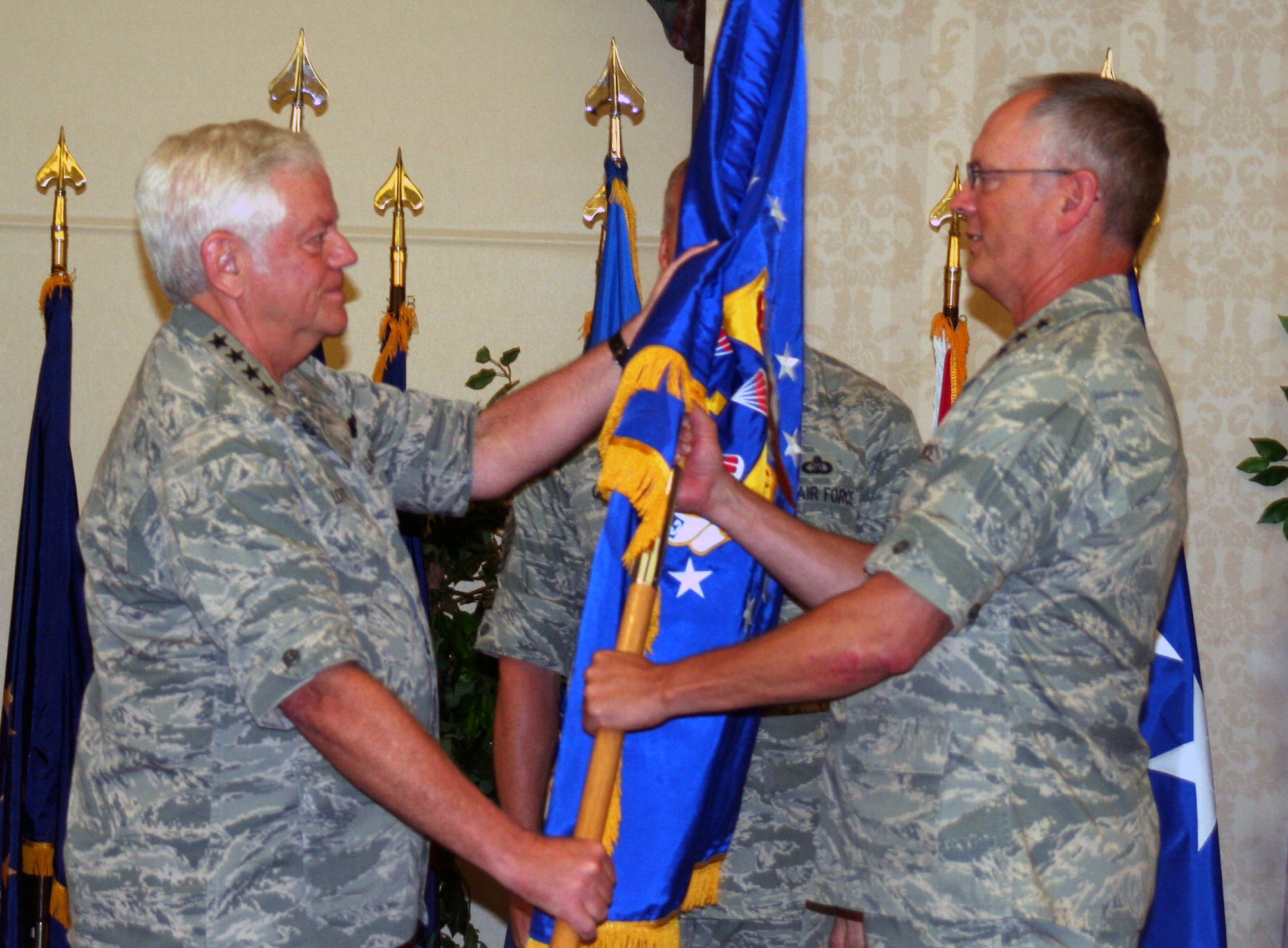 Gen. Arthur J. Lichte, Air Mobility Command commander, passes the flag of leadership for the 18th Air Force to Lt. Gen. Robert Allardice during a ceremony Aug. 19, 2009, at Scott Air Force Base, Ill. The 18th Air Force is AMC's sole warfighting numbered air force and is responsible for the command's worldwide operational mission. (U.S. Air Force Photo/Tech. Sgt. Scott T. Sturkol)
