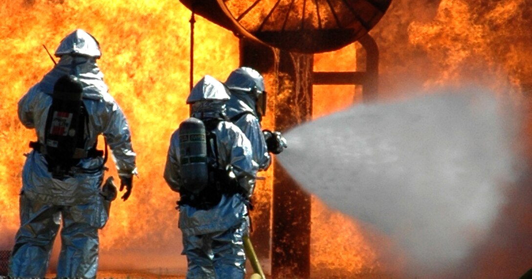 YOUNGSTOWN AIR RESERVE STATION, Ohio -- Citizen Airmen firefighters assigned to the 910th Civil Engineer Squadron participate in a simulated aircraft fuel fire exercise at the controlled burn pit here, July 12, 2009. This exercise is an annual requirement and helps provide the Airmen with the experience and proficiency needed to control various fire situations. The burn pit contains a propane-fueled aircraft frame that can burst into flames at the flick of a switch controlled by the exercise supervisors. U.S. Air Force photo by Airman 1st Class Megan Tomkins 