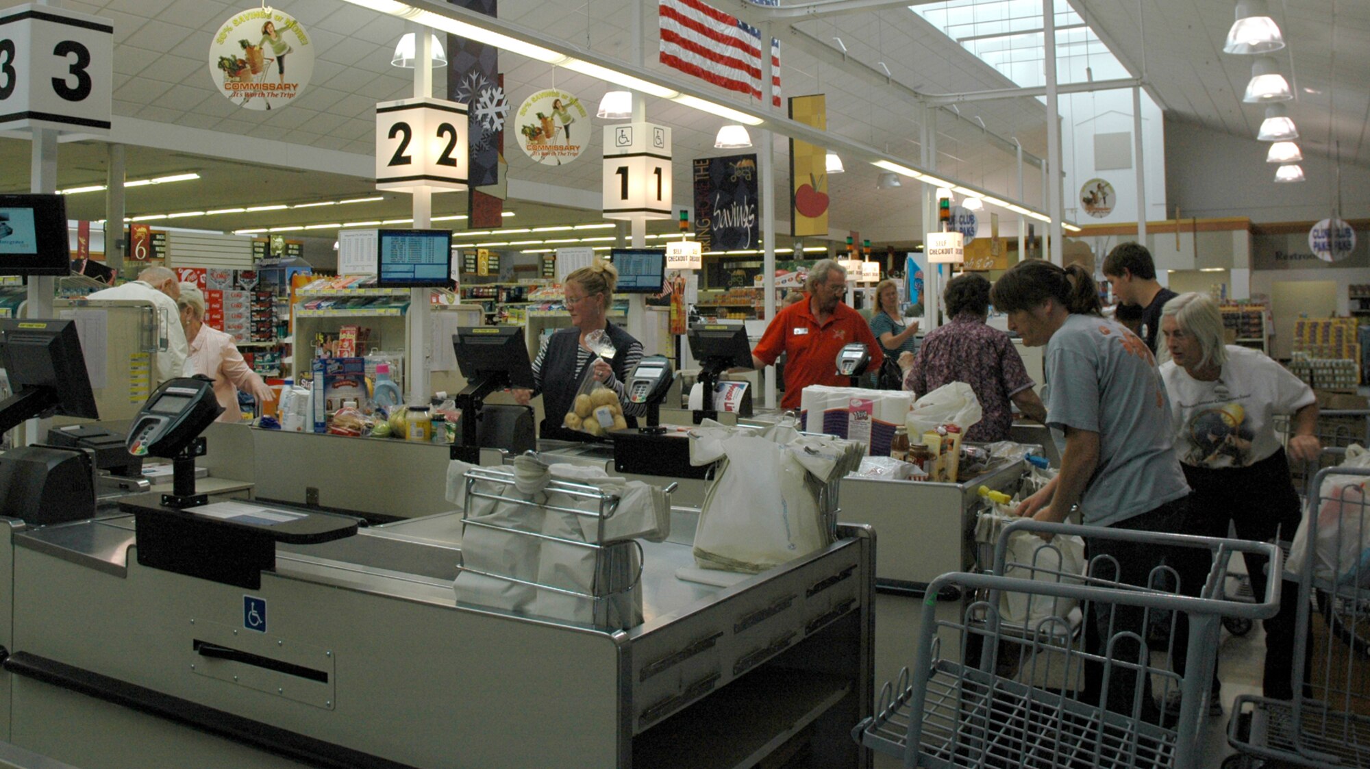 Commissary shoppers check out Aug. 18. Customer servcie at the cashier's area received a perfect score from the inspectors on their recent no-notice inspection stop at the Malmstrom commissary. (U.S. Air Force photo/Valerie Mullett)