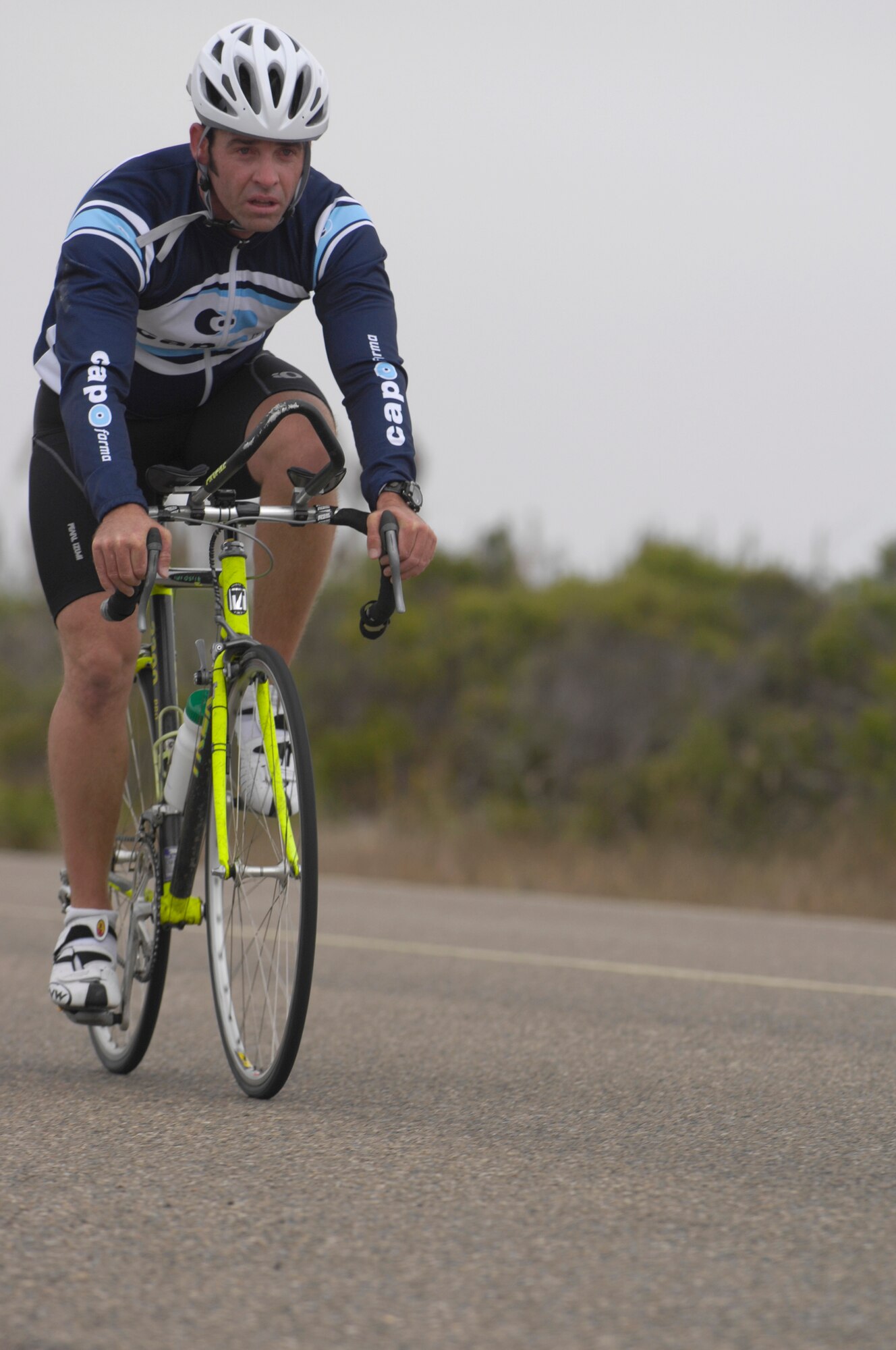 VANDENBERG AIR FORCE BASE, Calif. -- Nate Ogan pushes hard during the 20-kilometer bike ride portion of Vandenberg's triathalon here Aug. 16. Ogan and teammates Chuck Read and Kent Yankee took first place, finishing the triathlon in 59 minutes, 30 seconds. (U.S. Air Force photo/Airman 1st Class Andrew Lee) 
 