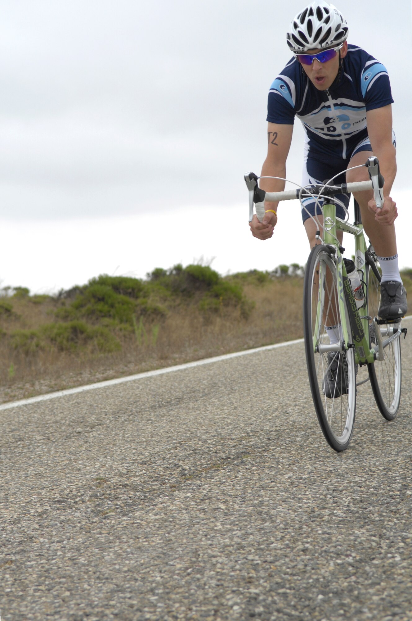 VANDENBERG AIR FORCE BASE, Calif. -- Michael Necessary pushes hard during the 20-kilometer bike ride portion of Vandenberg's triathalon here Aug. 16. Necessary, along with teammates Steve Bauer and Megan Lundstrom, took second place for the Team Division. The three athletes finished the 400-meter swim, 20-kilometer bike ride and 5-kilometer run in 1 hour, 8 minutes, 21 seconds. (U.S. Air Force photo/Airman 1st Class Andrew Lee) 