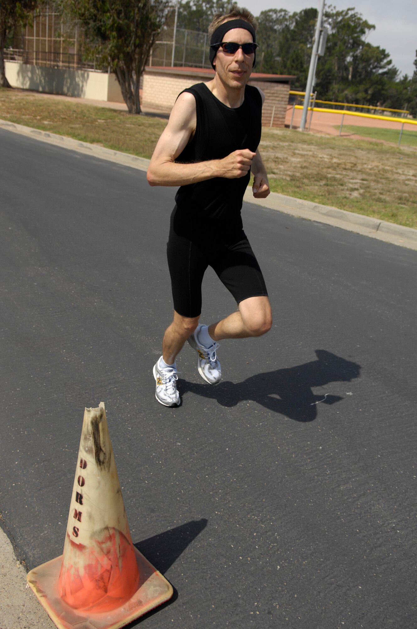 VANDENBERG AIR FORCE BASE, Calif. -- Swimming, biking, then running, Marc Berkstresser crosses the finish line after completing the last portion of Vandenberg's triathalon here Aug. 16. Berkstress is a lieutenant colonel with the 14th Air Force here. (U.S. Air Force photo/Airman 1st Class Andrew Lee) 
 