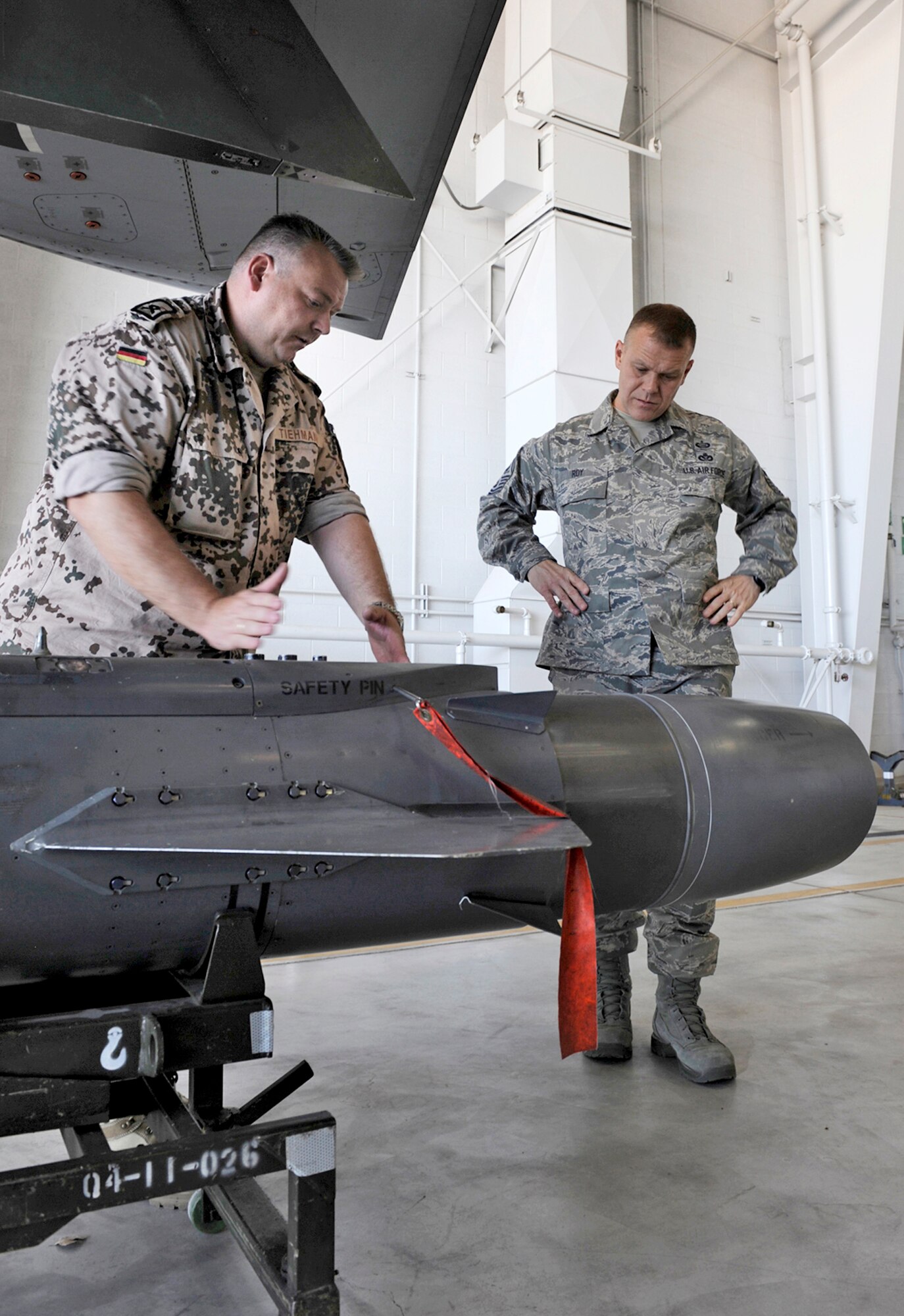 German air force Master Sgt. Joerg Tiehmann talks with Chief Master Sgt. of the Air Force James Roy about the weapon capabilities of the German aircraft, the Tornado. Chief Roy toured the base, talked to Airmen and answered their questions. Sergeant Tiehmann is a German air force first line maintenance supervisor of the training and standardization team. (U.S. Air Force photo/Senior Airman Tiffany Trojca)