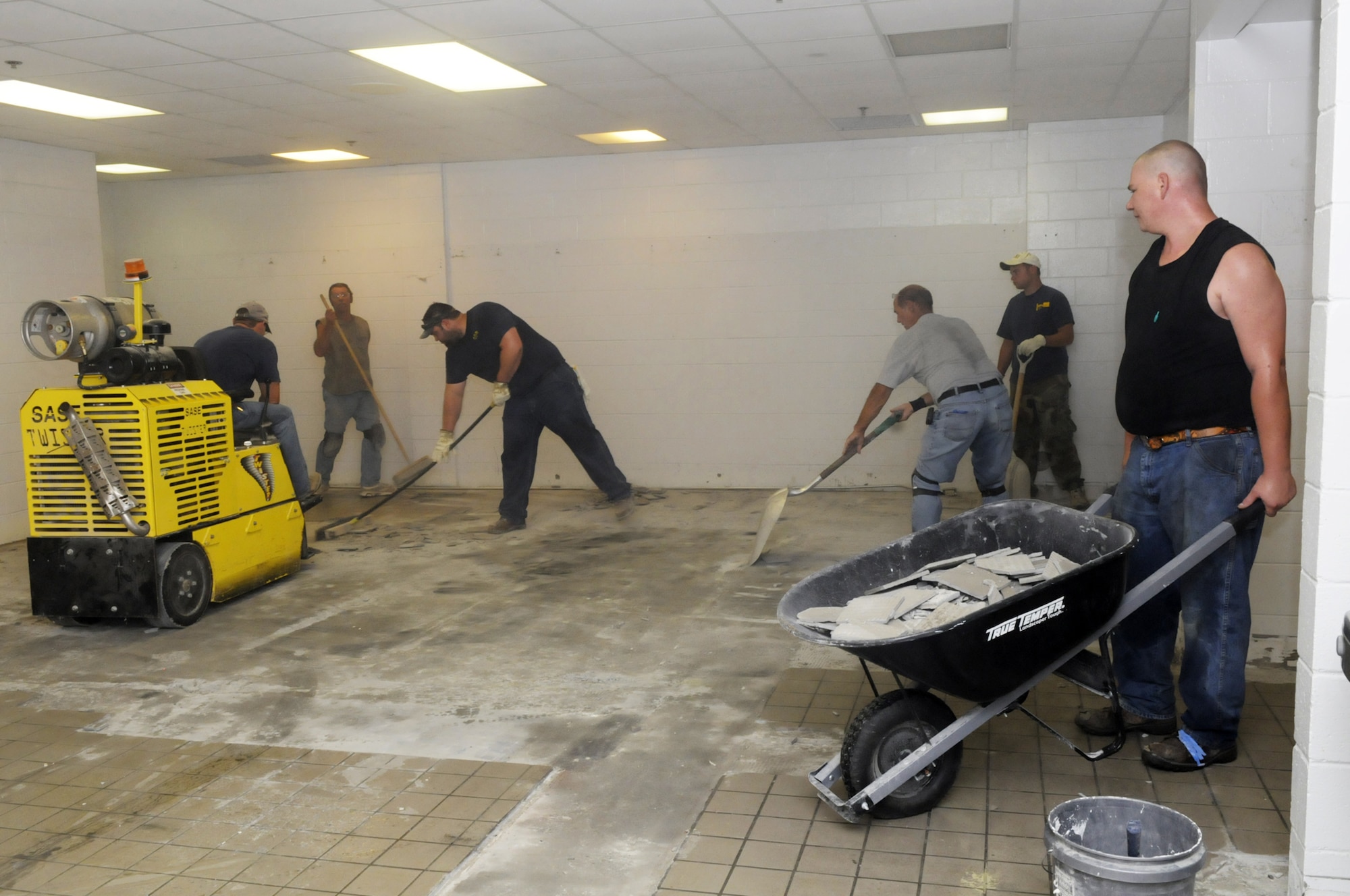 Workers remove the old tile in the women's locker room at the Fitness Center.  It's just one of dozens of projects the 78th Force Support Squadron is working to improve quality of life for its customers.  (U. S. Air Force photo by Sue Sapp)