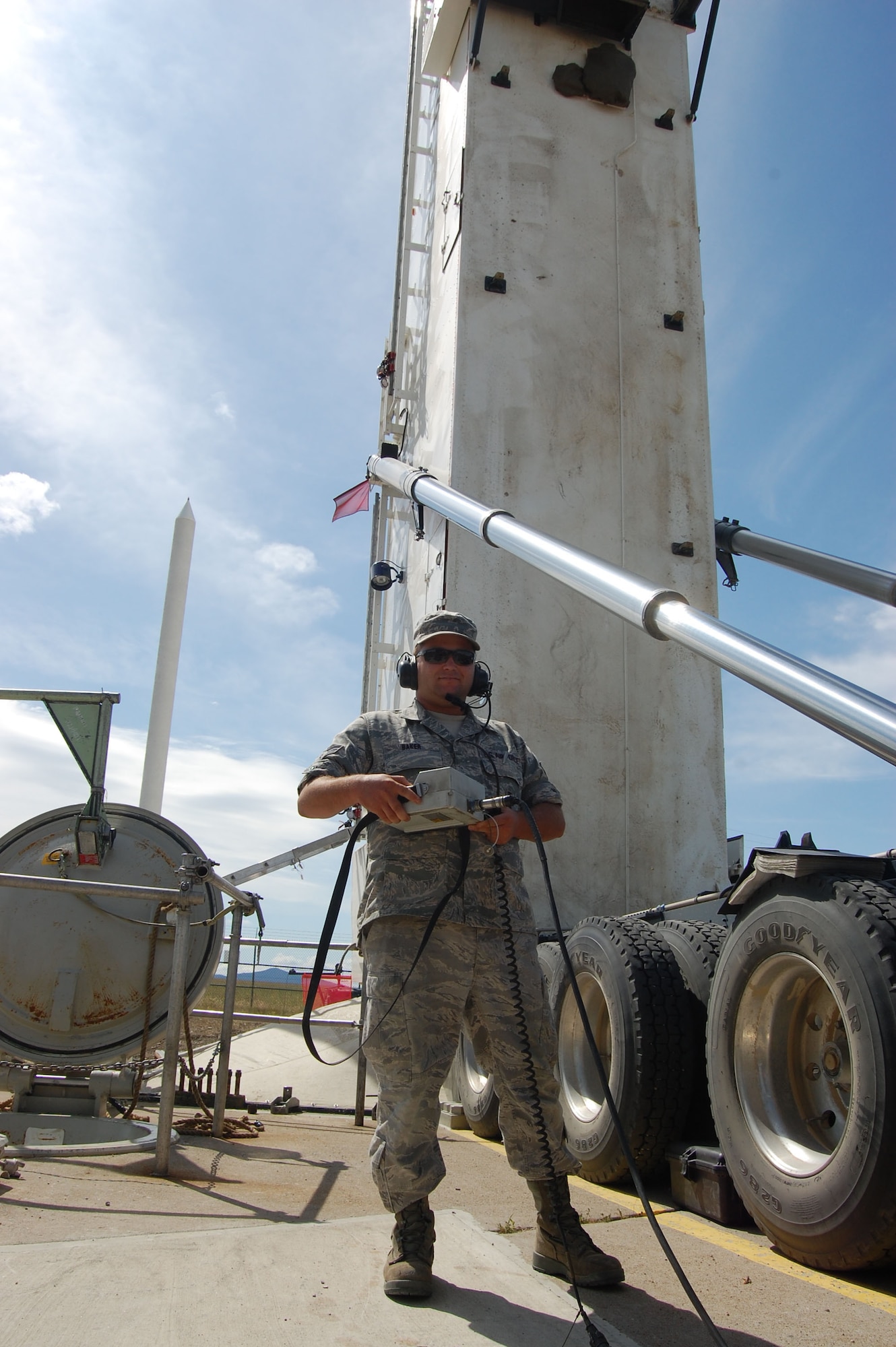 Senior Airman Derek Baker, 341st Missile Maintenance Squadron missile handling team technician, uses a hand-held controller to lower the 341st Missile Wing’s 150th Minuteman III solid-propellant replacement booster into launch facility Echo-08 Aug. 18. The Propulsion Replacement Program, or PRP, extends the service life of the missile through 2020. The first MMIII replacement booster was delivered in April 2001.  (U.S. Air Force photo/Staff Sgt. Eydie Sakura)