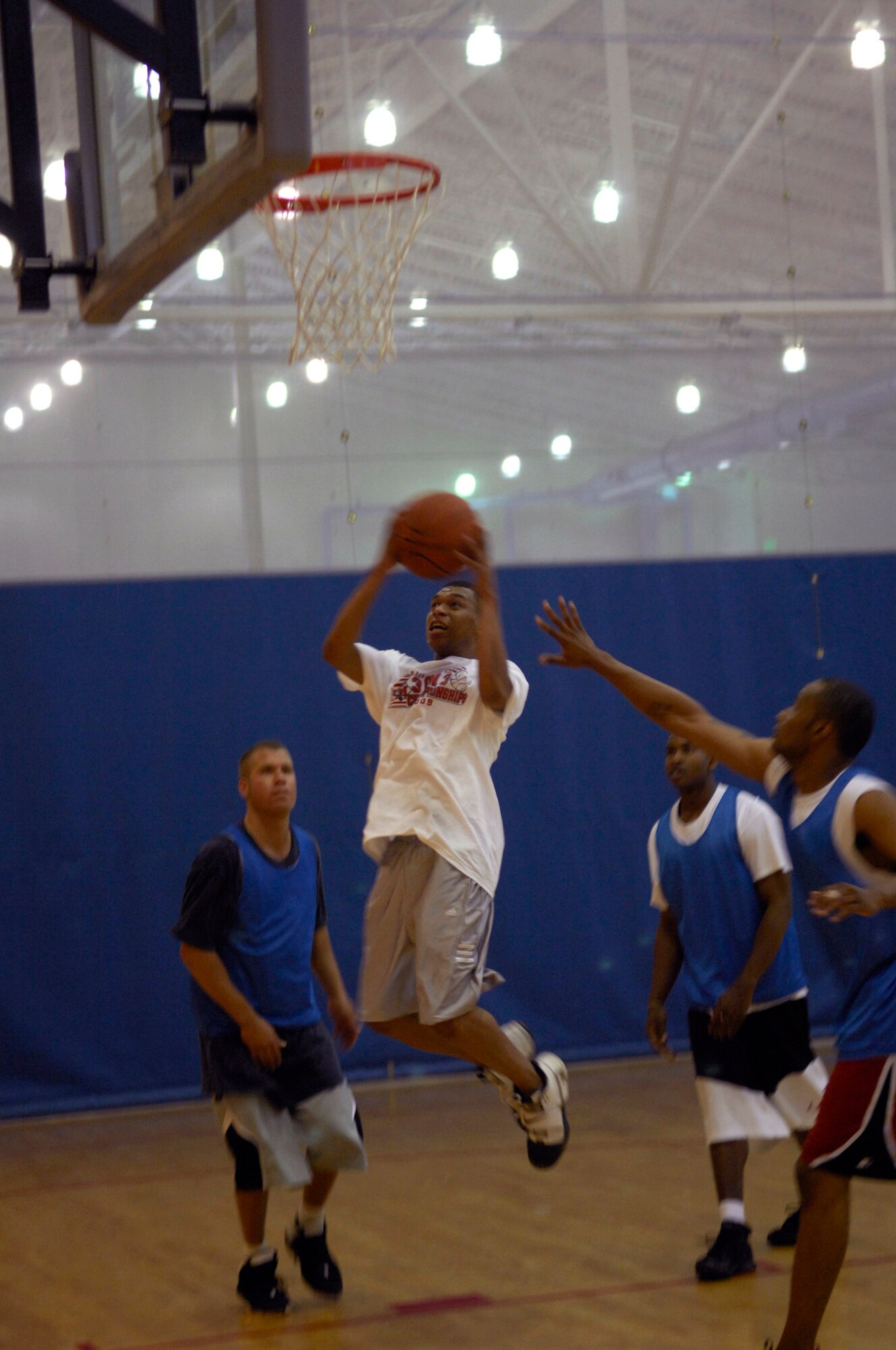 MINOT AIR FORCE BASE, N.D. – Airman 1st Class Earl Wills, 5th Mission Support Group (MSG), client support administrator, speeds past his defenders during a 3 on 3 basketball tournament as part of the annual MSG Wingman Day here, Aug. 14. The group held the event as a means to strengthen the morale and welfare of each unit by empowering and encouraging Airmen to not only become great wingmen, but future leaders. (U.S.  Air Force photo by Airman 1st Class Jesse Lopez)