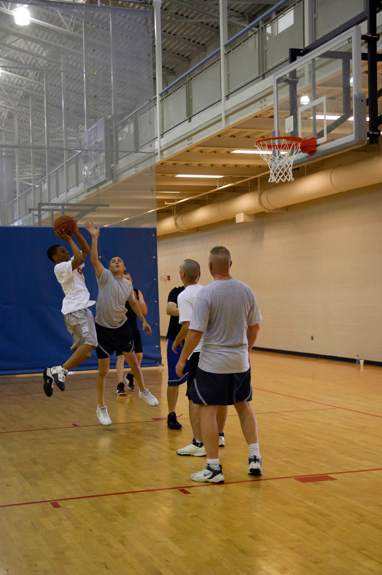 MINOT AIR FORCE BASE, N.D. – Airman 1st Class Earl Wills, 5th Mission Support Group (MSG), client support administrator, leads his team to victory over the 5th Communications Squadron during a 3 on 3 basketball tournament as part of the annual MSG Wingman Day here, Aug. 14. The group held the event as a means to strengthen the morale and welfare of each unit by empowering and encouraging Airmen to not only become great wingmen, but future leaders. (U.S.  Air Force photo by Airman 1st Class Jesse Lopez)