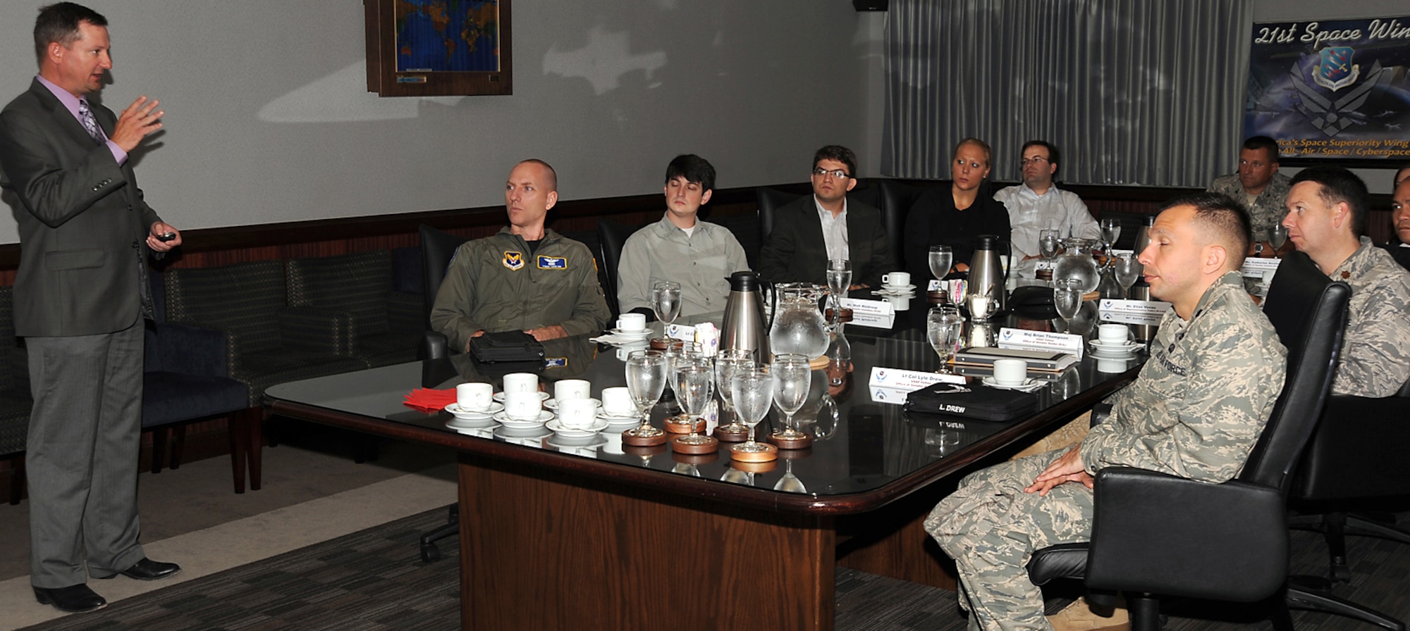 Congressional staffers and U.S. Air Force Fellows from 11 states across the nation were given the 21st Space Wing mission brief by Mr. Jeff Bohn, 21st Space Wing Public Affairs chief, during their visit to Colorado Springs Aug. 12. The liaisons learned about the wing’s vital space superiority mission, and share what they learned with Congress. During their trip they visited AFSPC, the Academy, Schriever AFB and SMDC/ARSTRAT to learn about the military missions and their role in the nation's defense. (Air Force photo by Roberta McDonald)