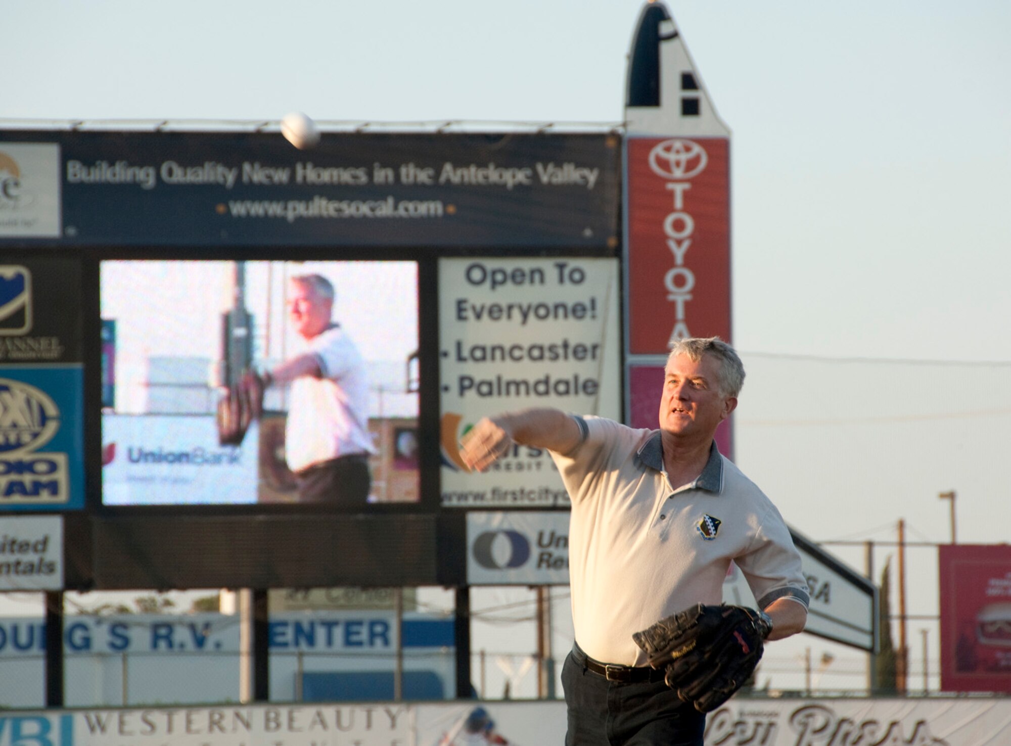 Maj. Gen. David Eichhorn, Air Force Flight Test Center commander, throws out the first pitch at the Lancaster JetHawks baseball game against the Bakersfield Blaze Aug. 15 at Clear Channel Stadium in Lancaster. General Eichhorn was joined by Bob Meyer, NASA Dryden Flight Research Center Sofia program manager, tossing out the ceremonial first pitch. The General was invited to the game as part of the JetHawks annual Aerospace Appreciation Night.(NASA photo/Tony Landis)