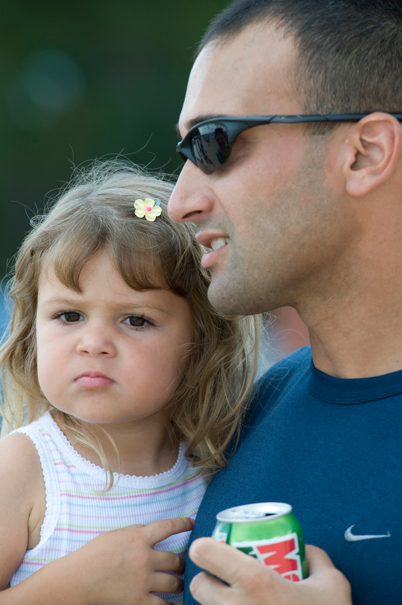 Maj. Aneel Alvares, 29th Training Systems Squadron, holds his daughter Claire during the 53rd Wing picnic festivities at Eglin Air Force Base, Aug. 14.  The morning was filled with sports events followed by lunch and more games at Eglin’s Post’l Point.  (U.S. Air Force photo/Debbie Haussermann.)