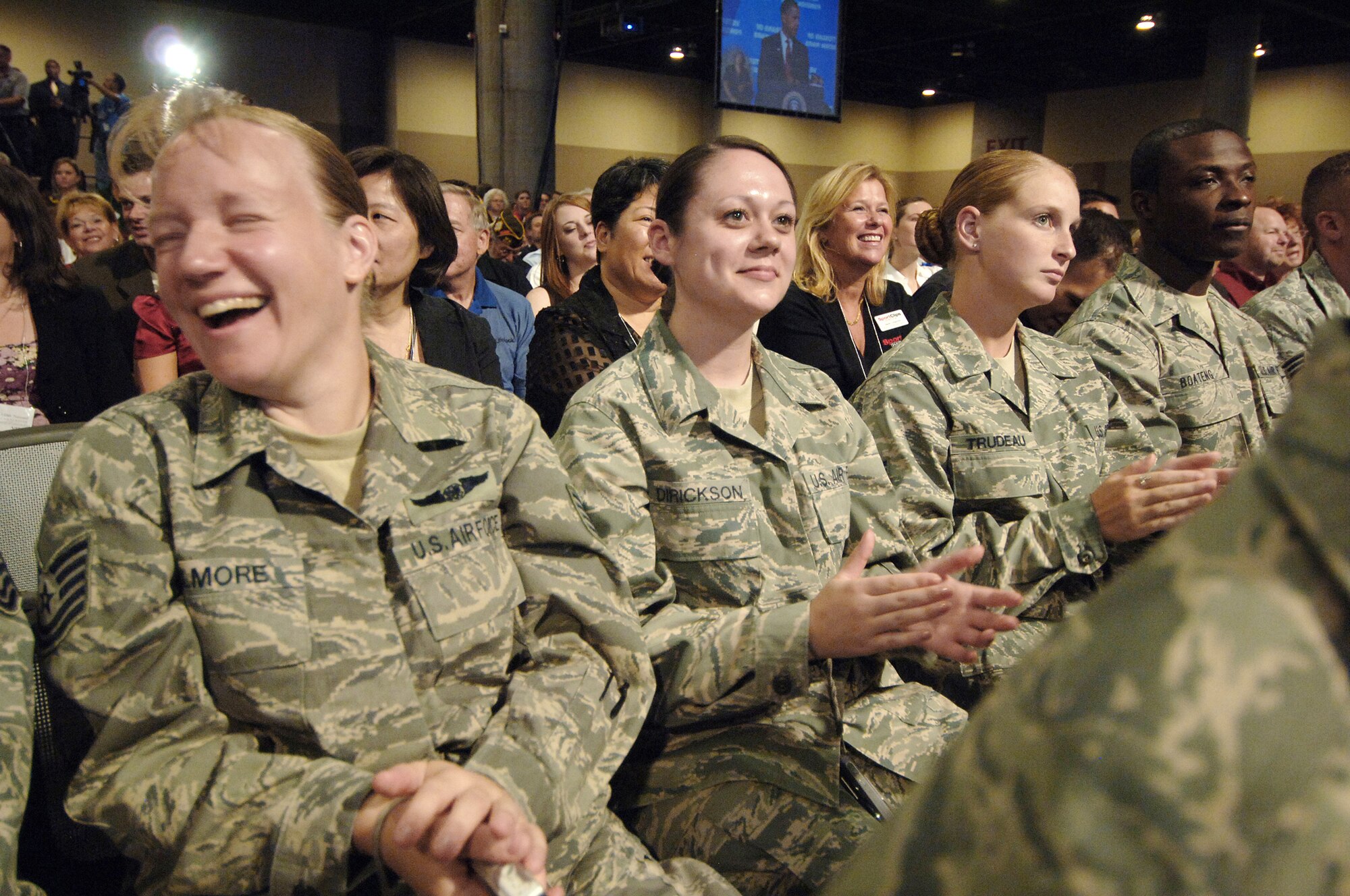 Airmen from Luke Air Force Base, Ariz., share a laugh while listening to President Barack Obama at the 110th Veterans of Foreign Wars National Convention at the Phoenix Convention Center Aug. 17. (U.S. Air Force photo/Tech. Sgt. Jeffrey A. Wolfe) 