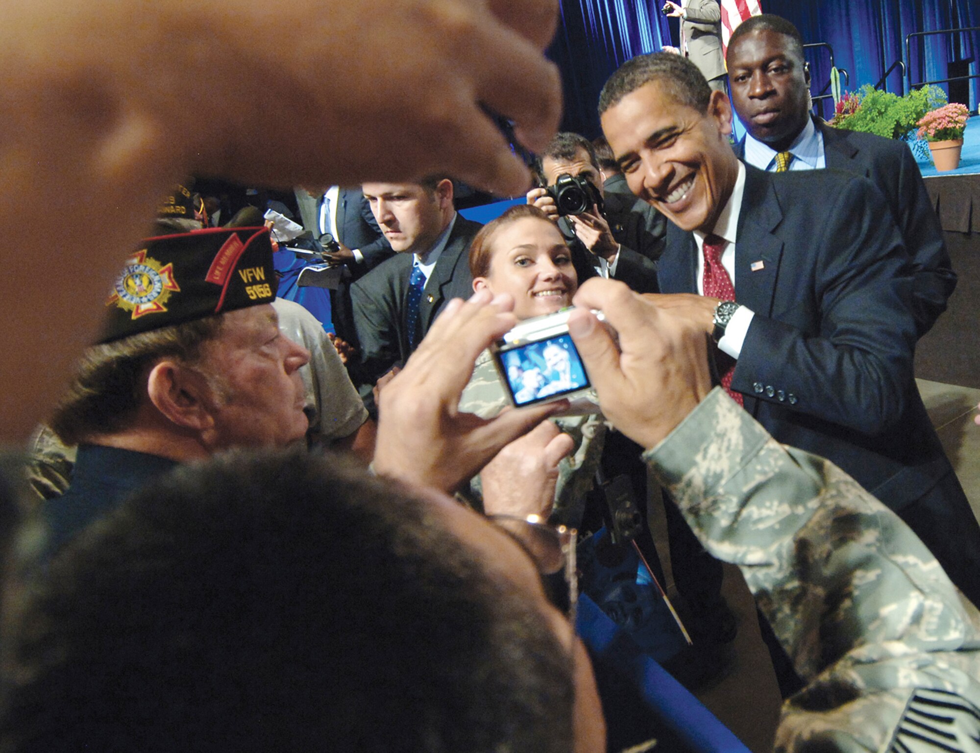 Capt. Kristen Gibson has her photo taken while giving President Barack Obama a "fist-bump" at the Veterans of Foreign Wars national convention held Aug. 17 in Phoenix. Captain Gibson is the 56th Operations Group executive officer. (U.S. Air Force photo/Tech. Sgt. Jeffrey A. Wolfe) 