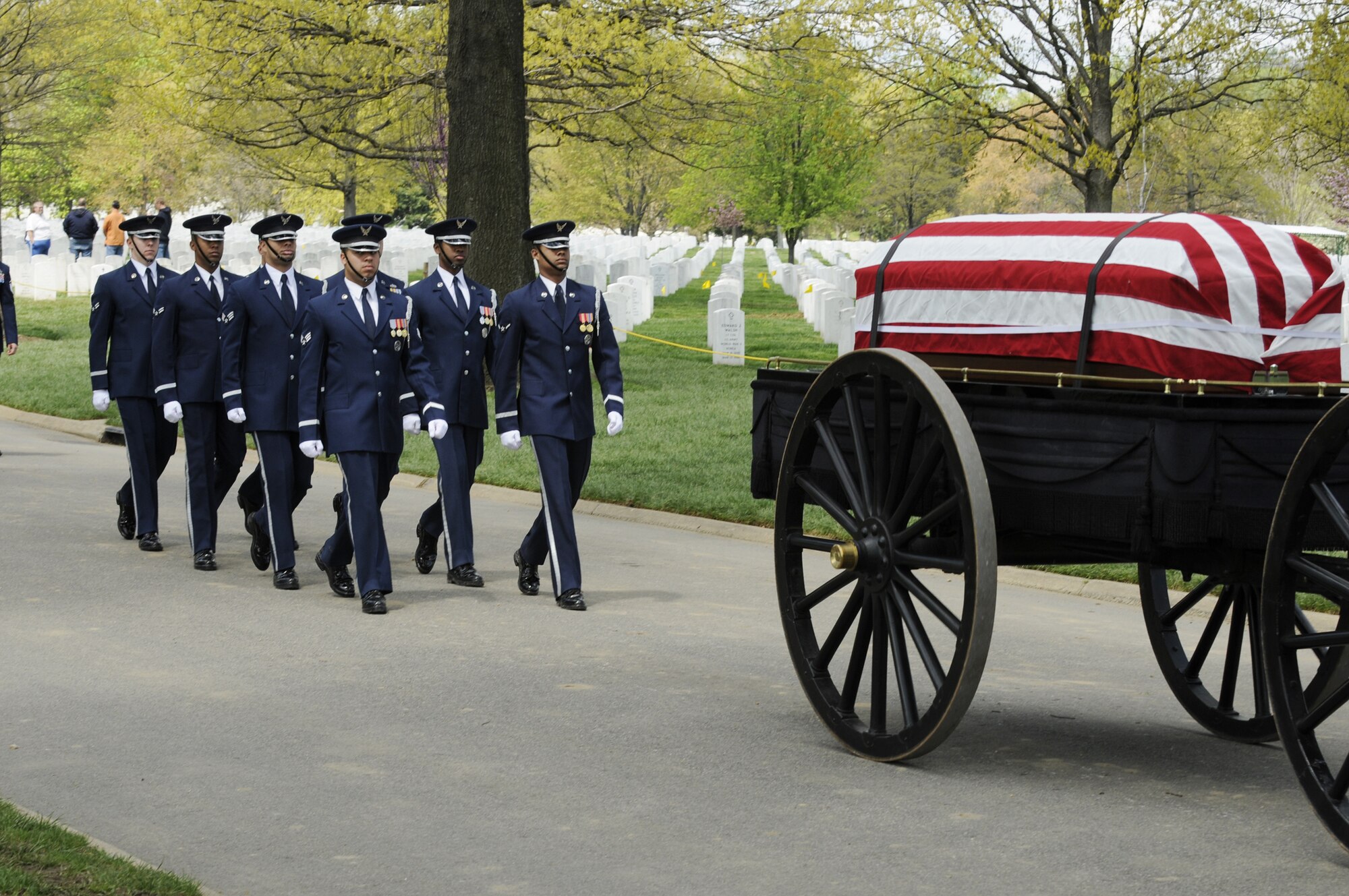 A United States Air Force Honor Guard body bearer team marches behind a caisson during a full-honors funeral ceremony at Arlington National Cemetery. Honor Guard body bearers train constantly to maintain the precision they are known for. Their standards of flawlessness are set out of necessity to honor fallen Airmen. (U.S. Air Force photo/Staff Sgt. Daniel DeCook) 