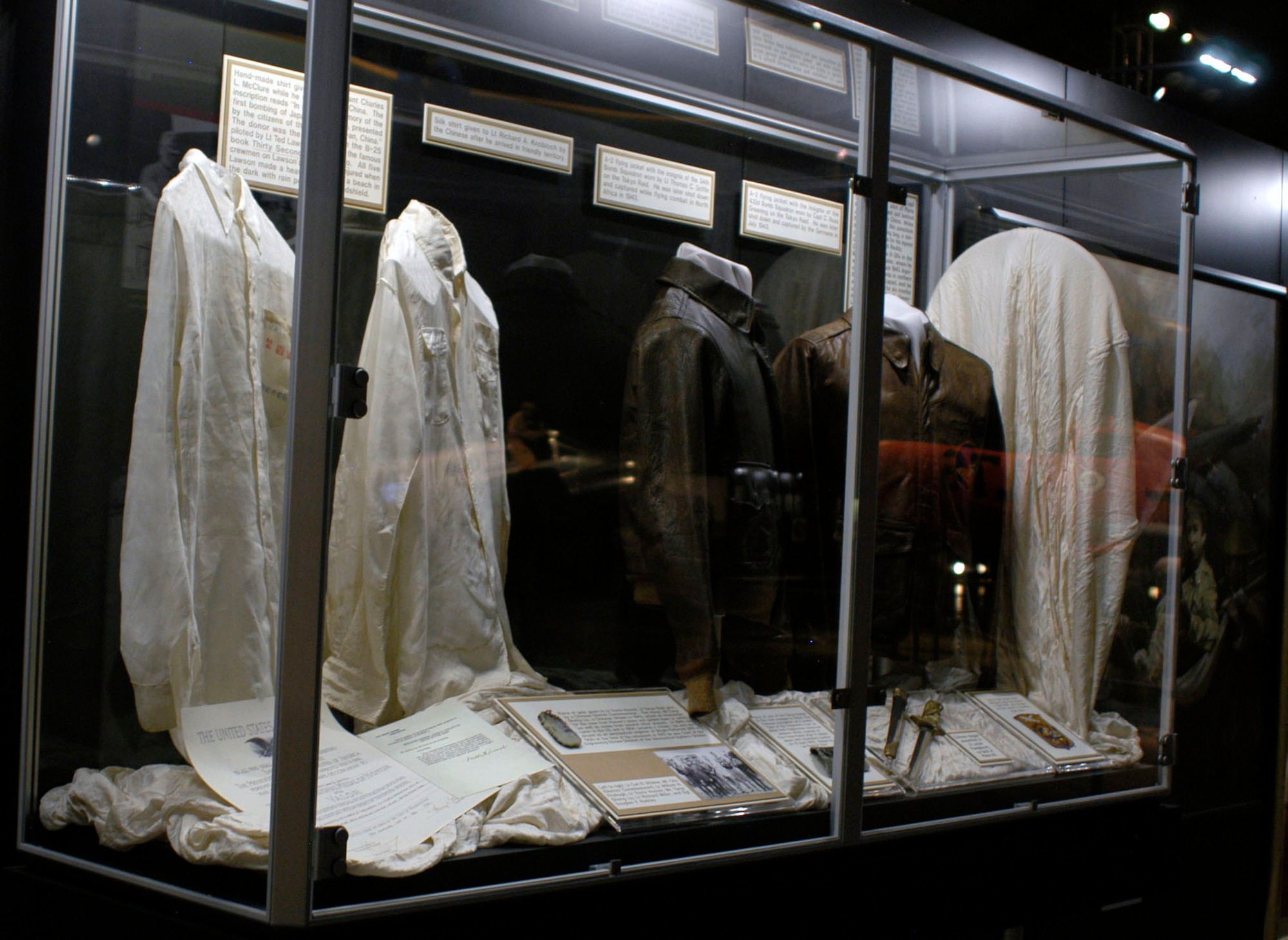DAYTON, Ohio -- Silk Shirts Worn by Raiders (left) and Raiders Flying Jackets (right) on display in the World War II Gallery at the National Museum of the U.S. Air Force. (U.S. Air Force photo)