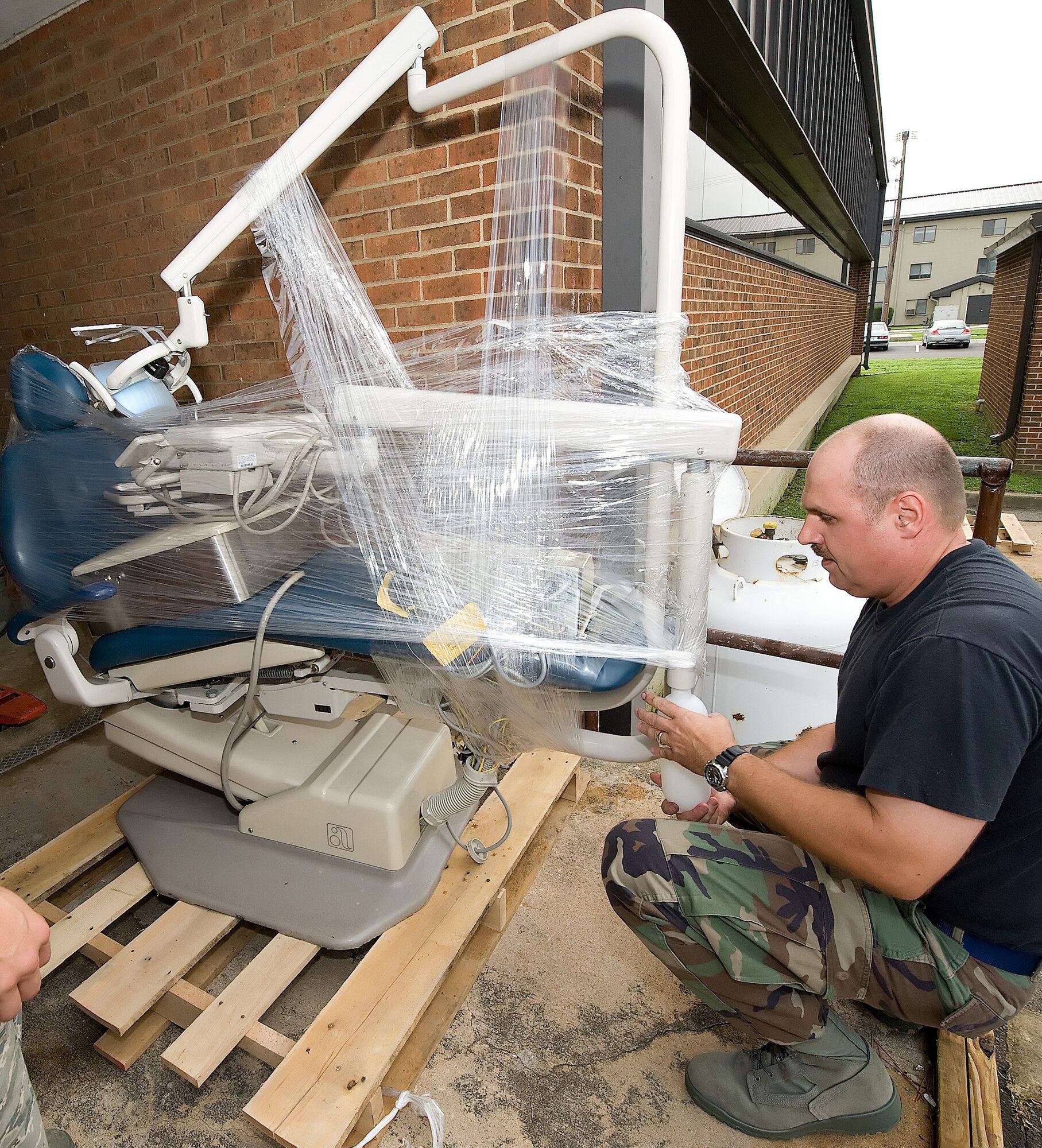Tech. Sgt. Raymond Worl, 436th Dental Squadron NCO in-charge of the dental laboratory, secures dental chairs onto a pallet. The 436th DS received new dental chairs Aug. 14. Sergeant Raymond and other members of the 436th DS assisted in the removal of the old chairs. (U.S. Air Force photo/ Jason Minto)