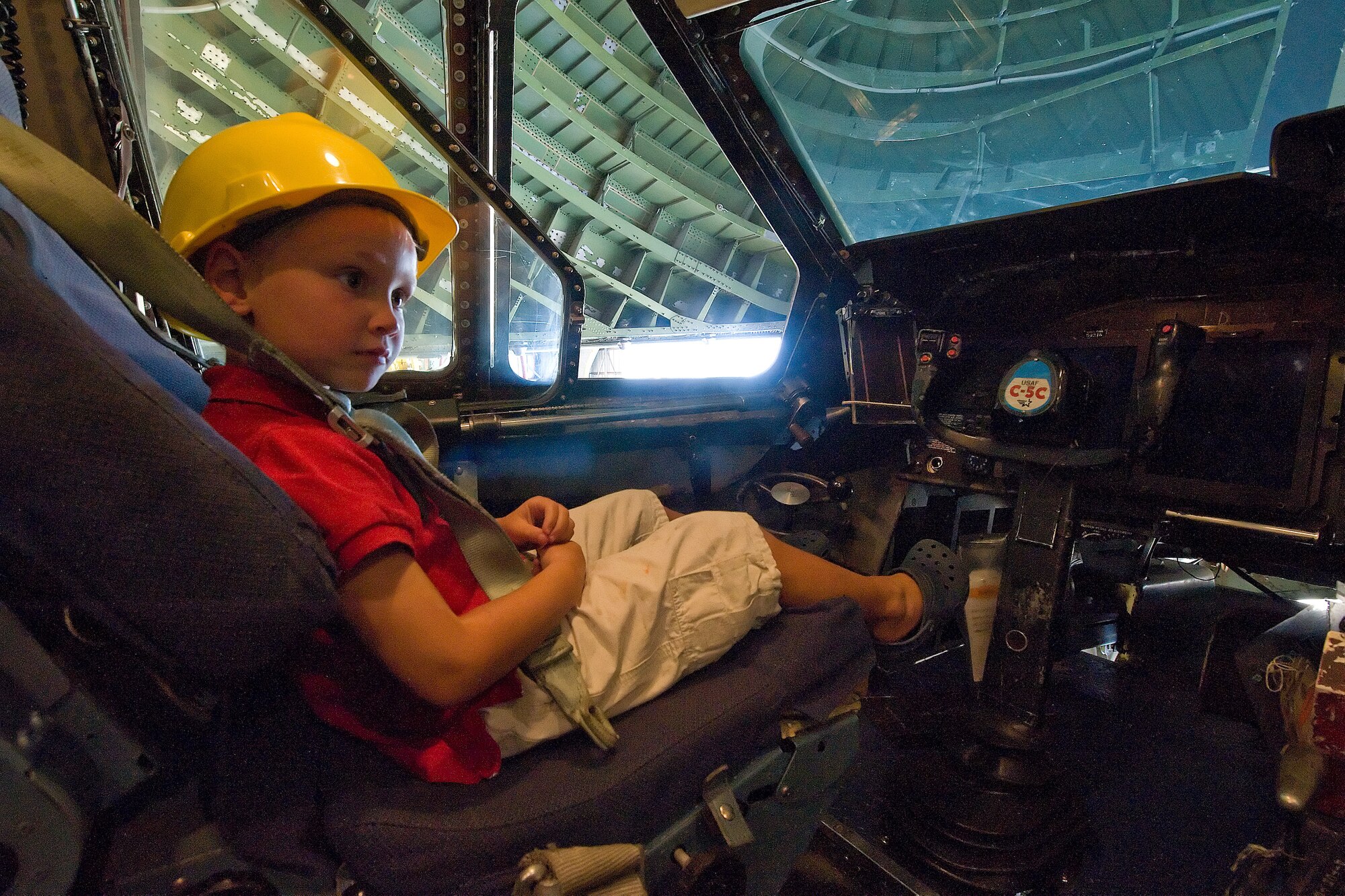Lex Johnson sits in the cockpit of a C-5 aircraft during a tour Aug. 3.  Johnson Relatives of former Staff Sgt. Julio Alonso, visited the base and Airman Leadership School.  The Dover Airman Leadership School is named after Sergeant Alonso.  (U.S. Air Force photo/Tom Randle)