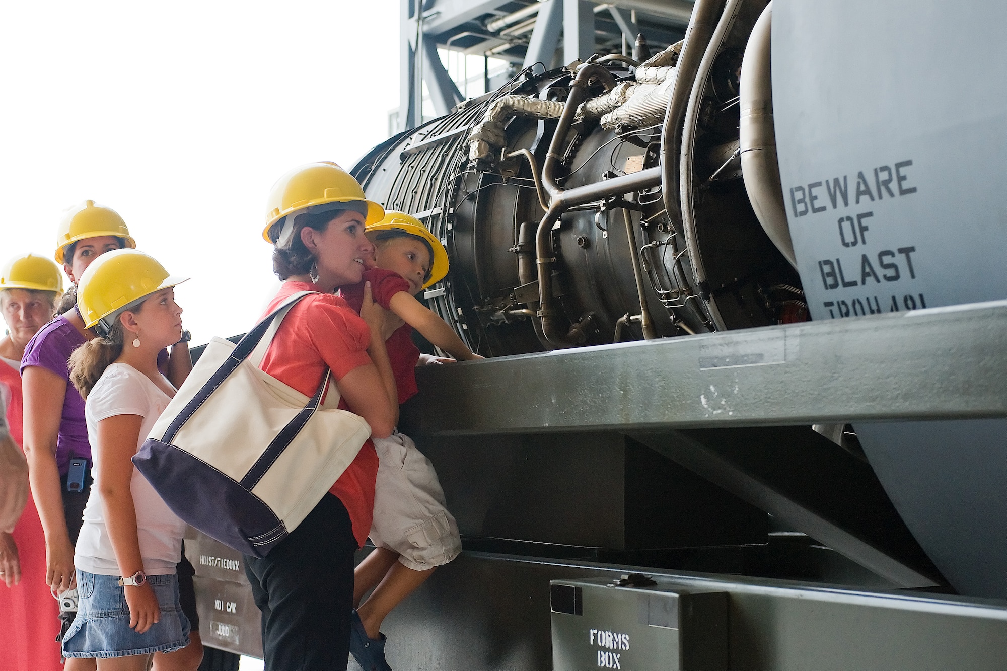 Stephanie Johnson holds up her son to see inside a C-5 engine.  Mrs. Johnson and her family came to tour the base and Airman Leadership School, which is named after her relative, former Staff Sgt. Julio Alonso.  (U.S. Air Force photo/Tom Randle)
