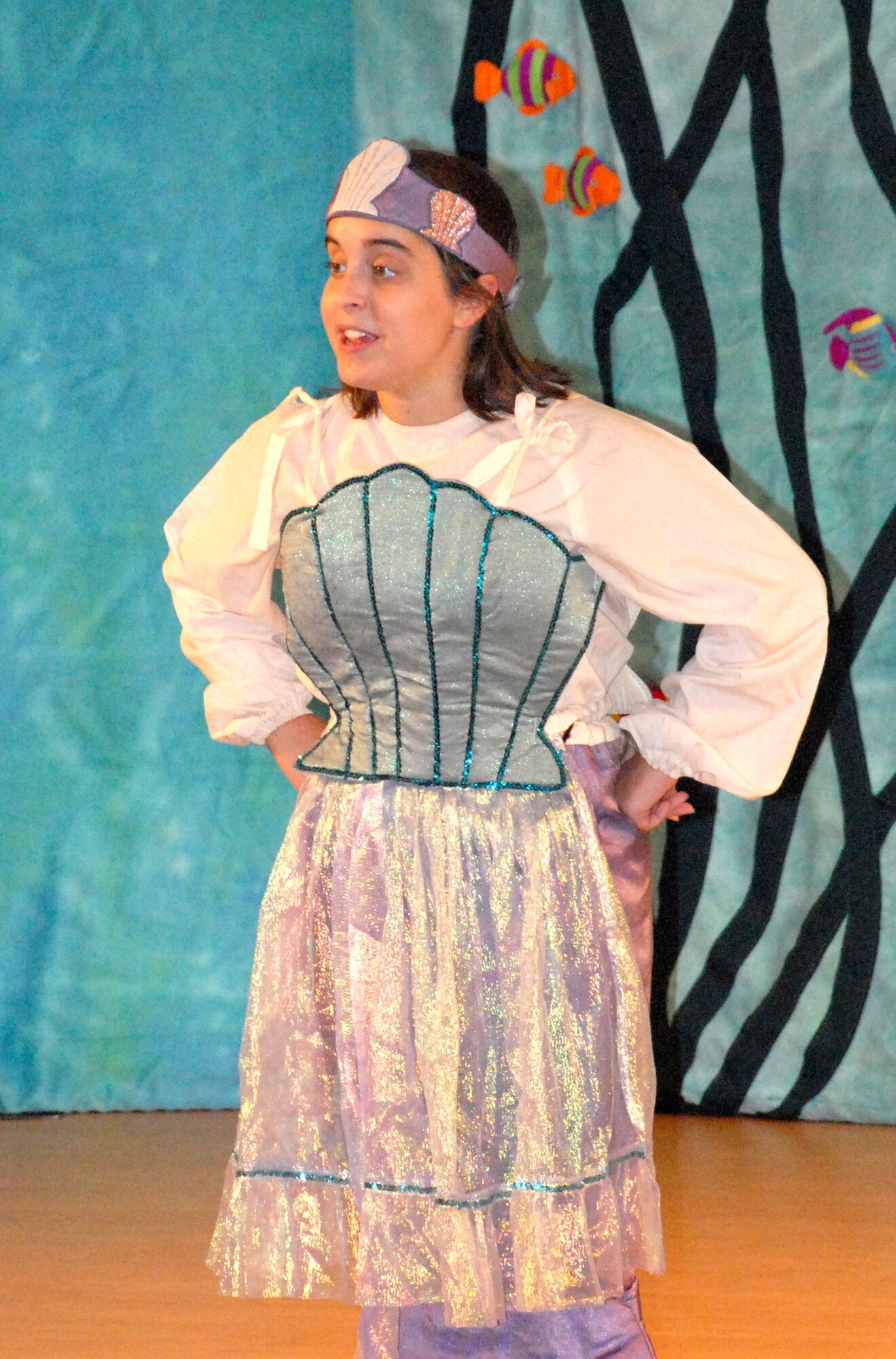 Caitlin White prepares the audience for a scene change during a dress rehearsal of 'The Little Mermaid' Aug. 14 at the Eagle Heights Youth Center. The Missoula Children's Theatre taught the children at the Youth Center how to put on a musical. (U.S. Air Force photo/Airman 1st Class Matthew Hubby)