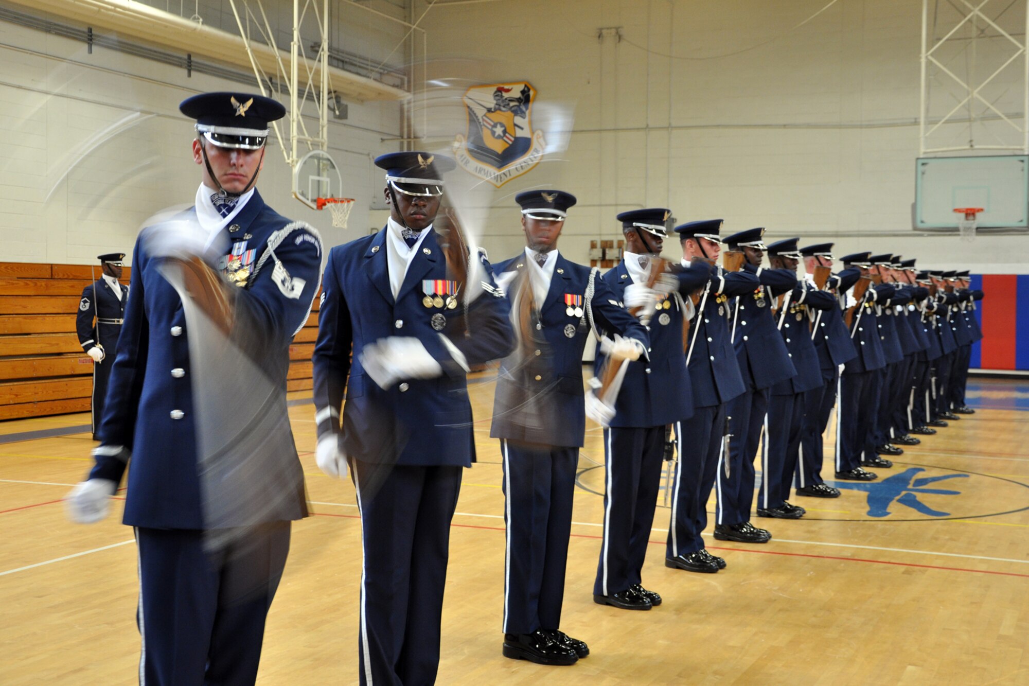 EGLIN AIR FORCE BASE, Fla. -- The USAF Honor Guard Drill Team performs for spectators at the fitness center here, Aug. 17. The 16-person team performed professionally choreographed sequence of weapon maneuvers, precise tosses, complex weapon exchanges and a walk through the gauntlet of spinning, 11-pound M-1 Garande rifles with fixed bayonets. The Drill Team is the traveling component of the USAF Honor Guard that promotes Air Force awareness among military and civilian audiences through their routines. (U.S. Air Force photo/ Airman Anthony Jennings)