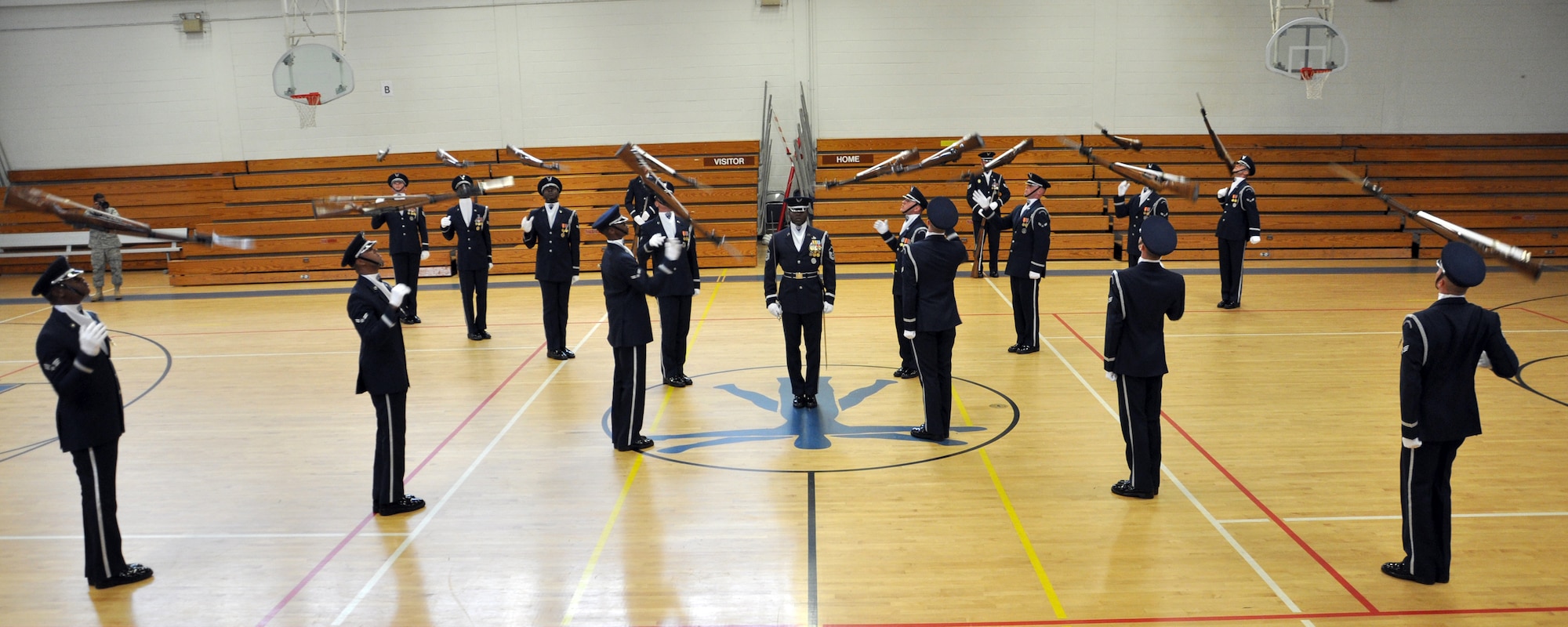 EGLIN AIR FORCE BASE, Fla. -- The USAF Honor Guard Drill Team performs for spectators at the fitness center here, Aug. 17. The 16-person team performed professionally choreographed sequence of weapon maneuvers, precise tosses, complex weapon exchanges and a walk through the gauntlet of spinning, 11-pound M-1 Garande rifles with fixed bayonets. The Drill Team is the traveling component of the USAF Honor Guard that promotes Air Force awareness among military and civilian audiences through their routines. (U.S. Air Force photo/ Airman Anthony Jennings)