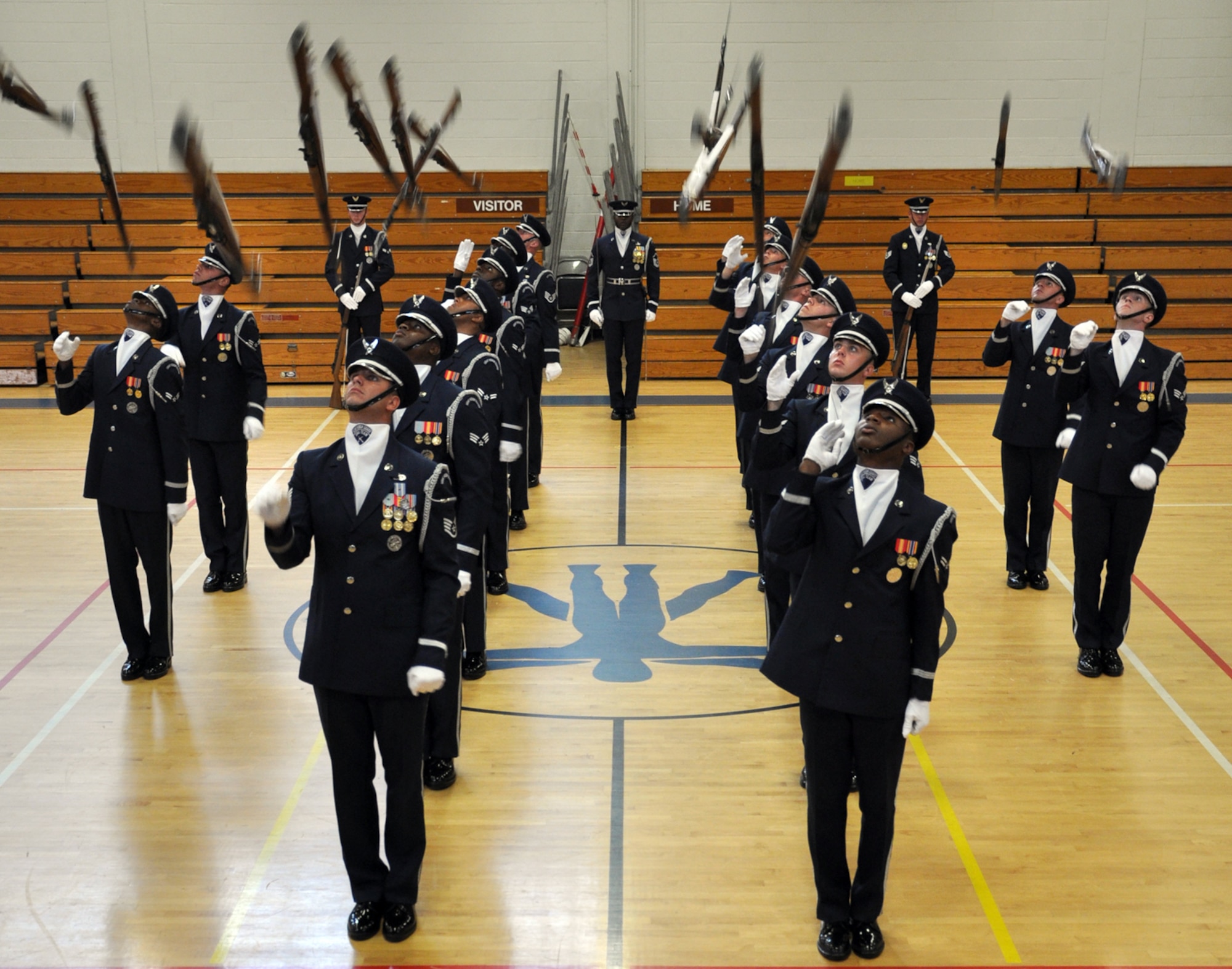 EGLIN AIR FORCE BASE, Fla. -- The USAF Honor Guard Drill Team performs for spectators at the fitness center here, Aug. 17. The 16-person team performed professionally choreographed sequence of weapon maneuvers, precise tosses, complex weapon exchanges and a walk through the gauntlet of spinning, 11-pound M-1 Garande rifles with fixed bayonets. The Drill Team is the traveling component of the USAF Honor Guard that promotes Air Force awareness among military and civilian audiences through their routines. (U.S. Air Force photo/ Airman Anthony Jennings)