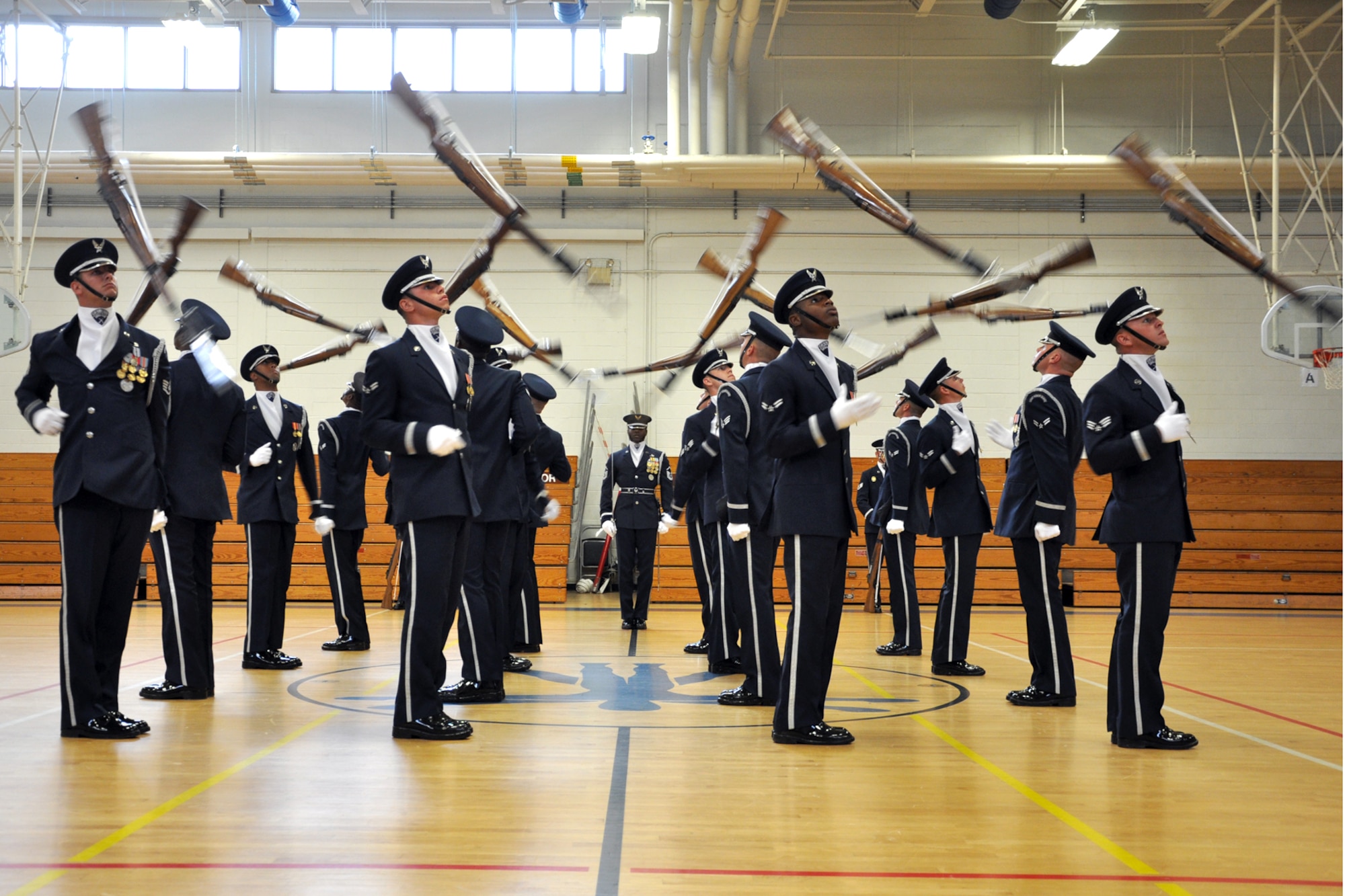 EGLIN AIR FORCE BASE, Fla. -- The USAF Honor Guard Drill Team performs for spectators at the fitness center here, Aug. 17. The 16-person team performed professionally choreographed sequence of weapon maneuvers, precise tosses, complex weapon exchanges and a walk through the gauntlet of spinning, 11-pound M-1 Garande rifles with fixed bayonets. The Drill Team is the traveling component of the USAF Honor Guard that promotes Air Force awareness among military and civilian audiences through their routines. (U.S. Air Force photo/ Airman Anthony Jennings)