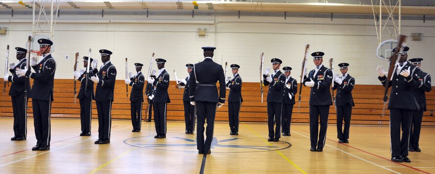 EGLIN AIR FORCE BASE, Fla. -- The USAF Honor Guard Drill Team performs for spectators at the fitness center here, Aug. 17. The 16-person team performed professionally choreographed sequence of weapon maneuvers, precise tosses, complex weapon exchanges and a walk through the gauntlet of spinning, 11-pound M-1 Garande rifles with fixed bayonets. The Drill Team is the traveling component of the USAF Honor Guard that promotes Air Force awareness among military and civilian audiences through their routines. (U.S. Air Force photo/ Airman Anthony Jennings)