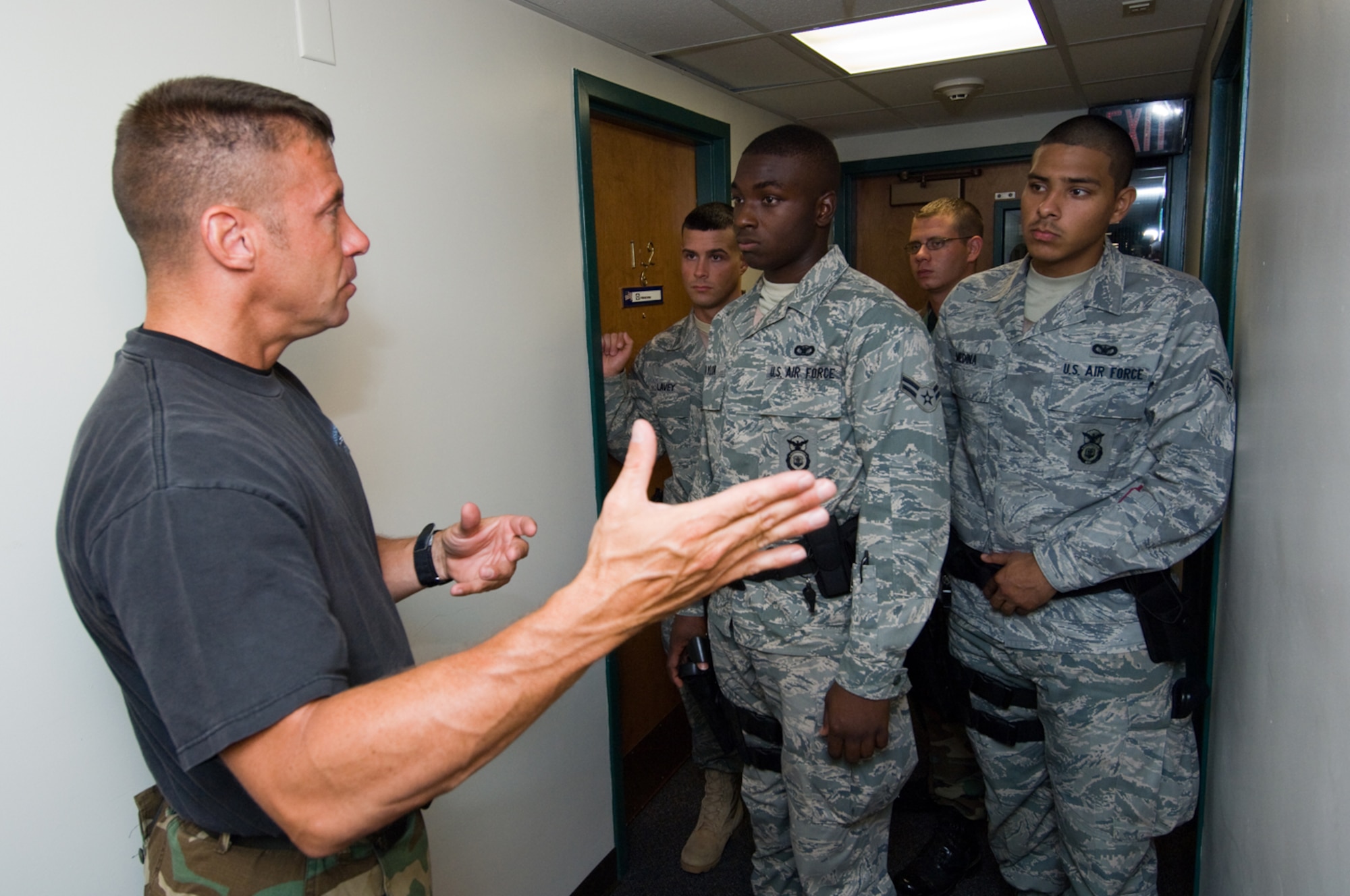 HANSCOM AIR FORCE BASE, Mass. - Jim O’Donnell, Massachusetts State Police Special Tactical Operations Team, gives (from left) Airman 1st Class Jeffrey Lavey, Airman 1st Class Nicholas Taylor, Staff Sgt. Christopher Darrow and Airman 1st Class Abraham Medina, all with the 66th Security Forces Squadron, instruction on neutralizing an active shooter within the dormitories during training here Aug. 6. (U.S. Air Force photo by Rick Berry)

