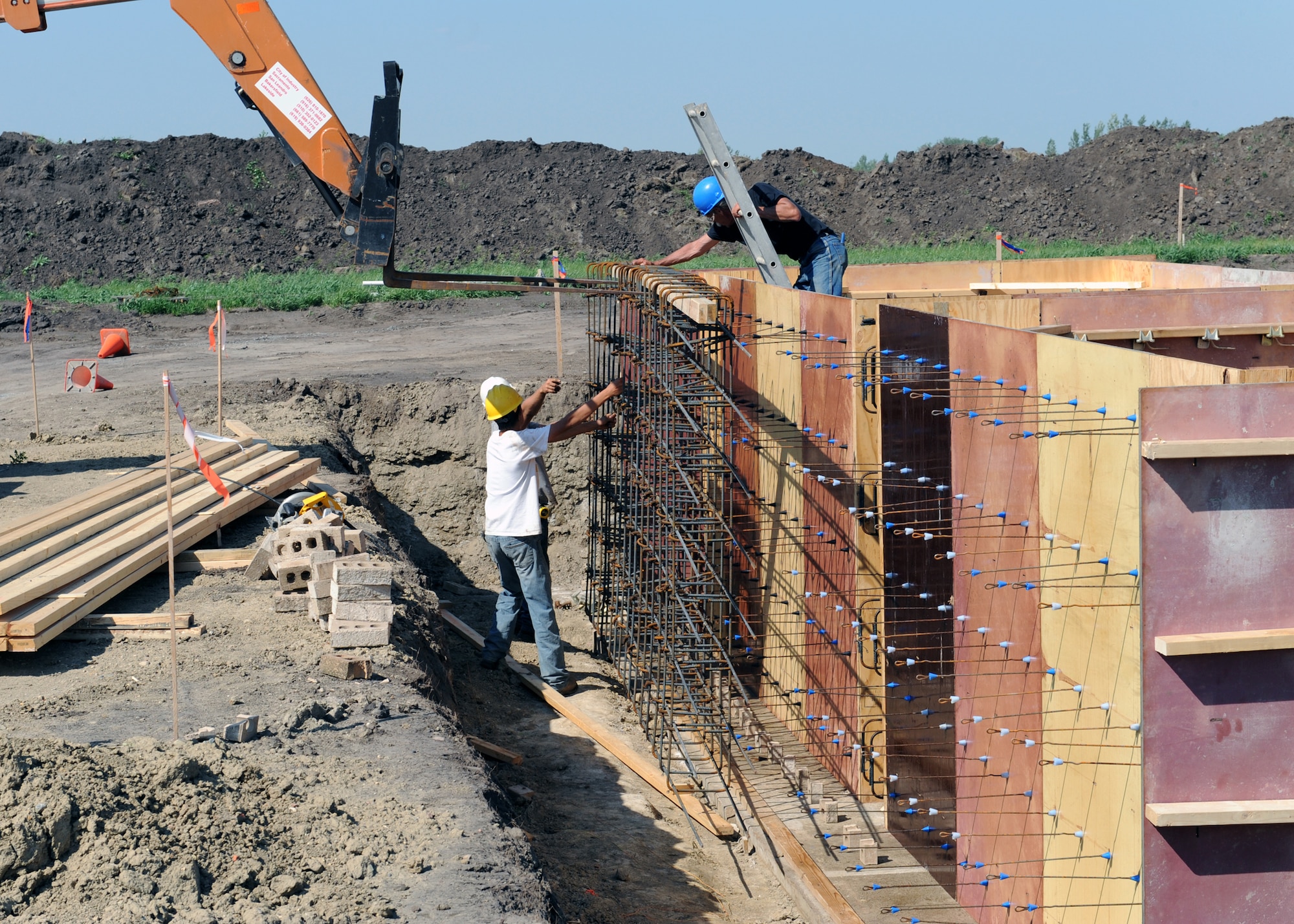 MINOT AIR FORCE BASE, N.D. -- Members of Telehey Construction Company position a reinforcing wall designed to add strength to a concrete foundation at a new radar site here, Aug. 11. The digital airport surveillance radar, or DASR-11 program, is expected to be completed in April of 2010. The DASR-11 will be able to track, discern between military and civilian aircraft in and around the city of Minot.  (U.S. Air Force photo by Staff Sgt. Keith Ballard)