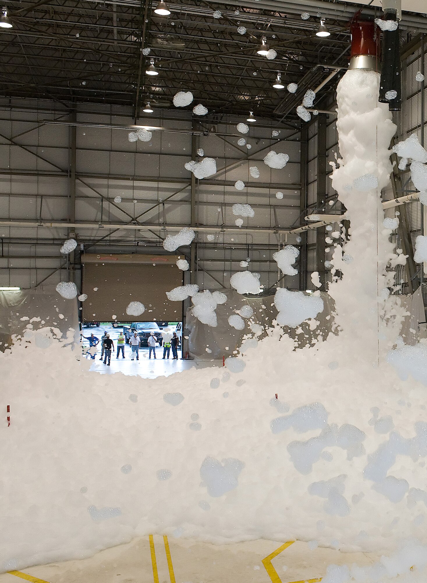 Foam fills Hanger 945 during a preliminary flow test Aug. 12. The test was for a newly-installed fire safety system using 2 percent high expansive foam. (U.S. Air Force photo/Tom Randle)
