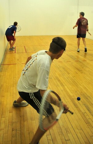 Austin Fields, 16, swings for a low-flying ball during a game of racquetball at the Fitness and Sports Center here Aug. 14. The racquetball courts are open to military family youth, ages 13-15, with adult supervision and all customers 16 and older with a Department of Defense individual identification card. Fields is the son Master Sgt. Leland Fields, a loadmaster superintendent with the 437th Operations Group. (U.S. Air Force photo/Staff Sgt. Daniel Bowles)