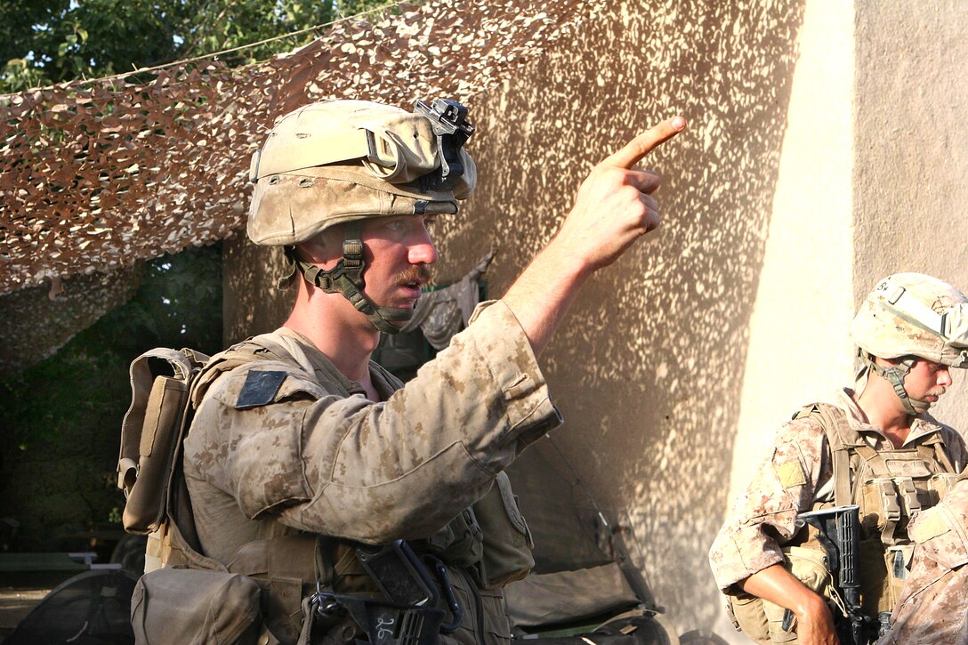 U.S. Marine Corps Sgt. Matthew Burrell orients his Marines to the direction of movement before moving out on a patrol in Garmsir district in Helmand province, Afghanistan, Aug. 10, 2009. Burrell is a squad leader assigned to Echo Company, 2nd Battalion, 8th Marine Regiment.